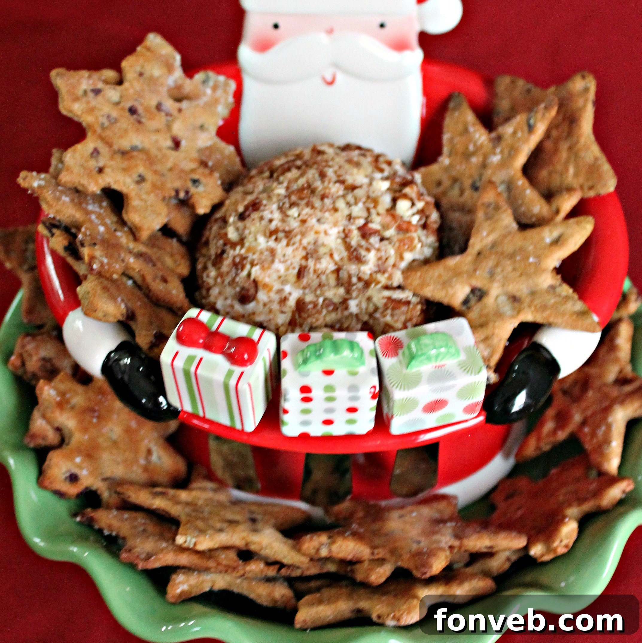 A generous slice of Bacon Cheddar Ranch Pecan Ball on a cracker, showing the creamy interior and pecan crust.