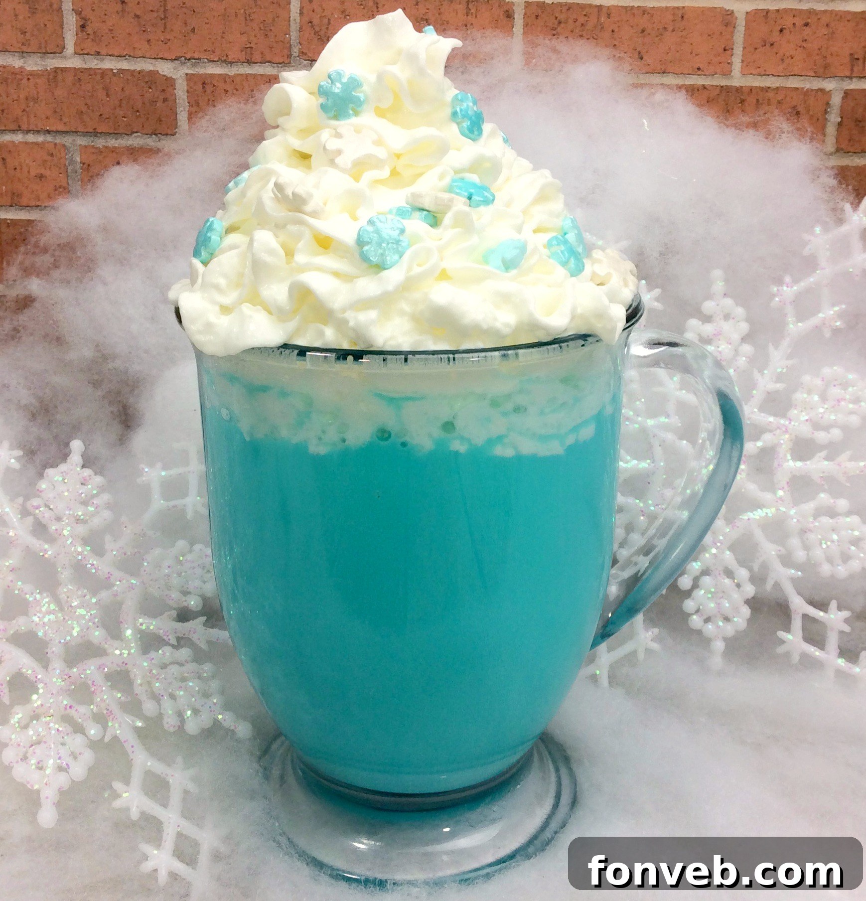 Close-up of the blue hot cocoa, showcasing the creamy texture and the contrast between the vivid blue drink and the white whipped cream, adorned with sparkling sprinkles.