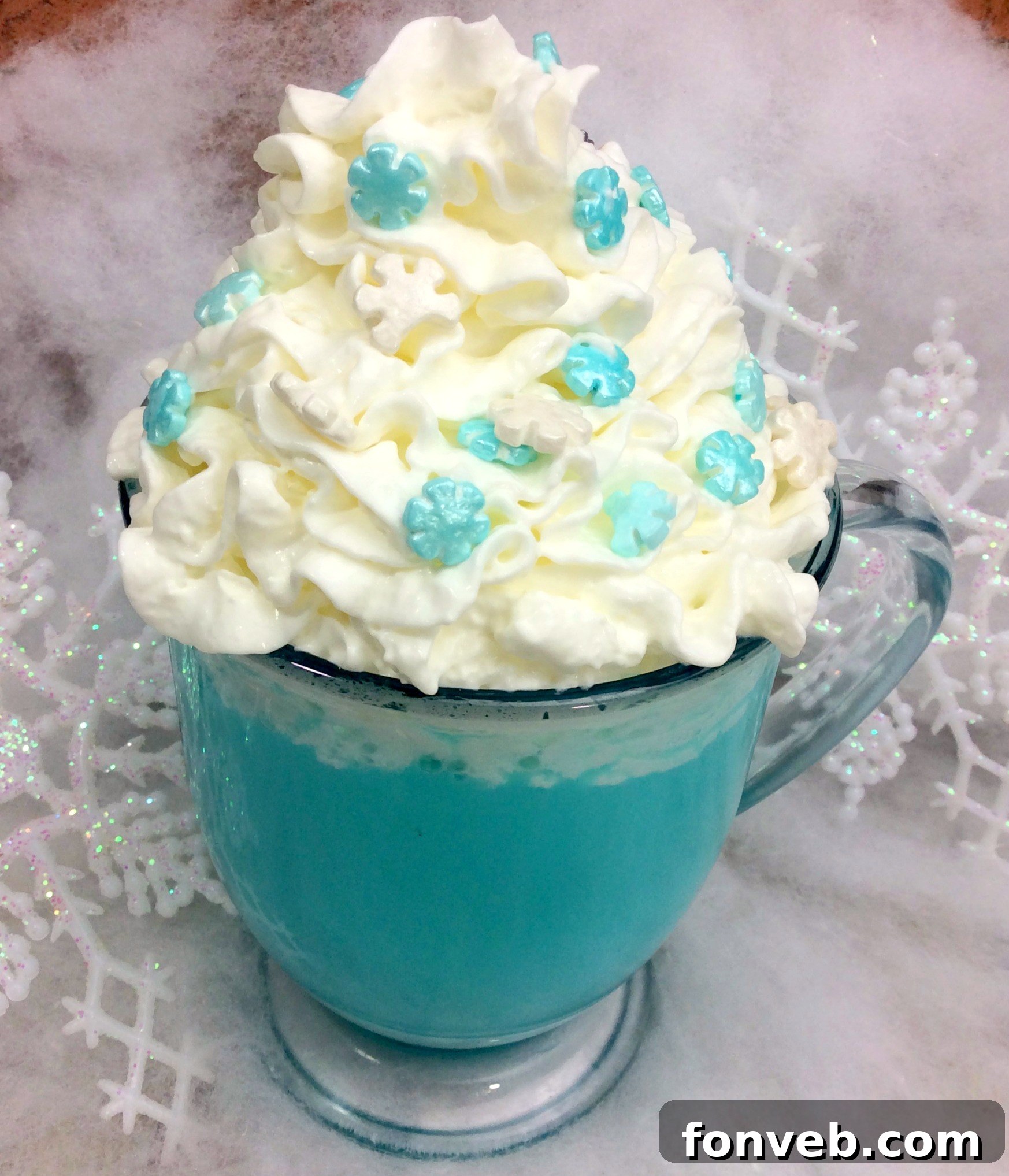 Another perspective of the blue hot cocoa mug, emphasizing the festive presentation with sprinkles and a cozy, inviting atmosphere.