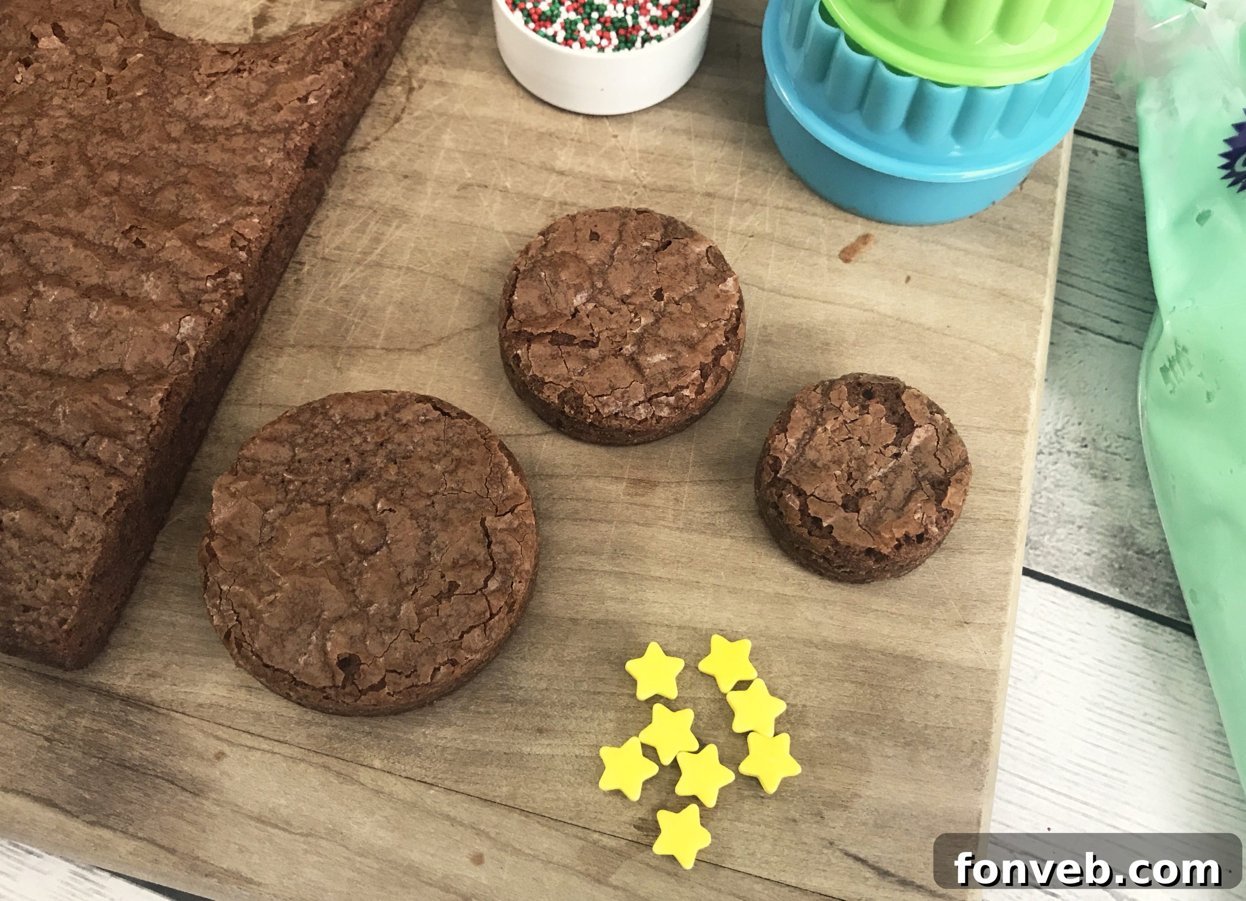 Essential ingredients for baking brownie Christmas trees laid out, including a brownie mix box, eggs, oil, and water, emphasizing the recipe's simplicity.