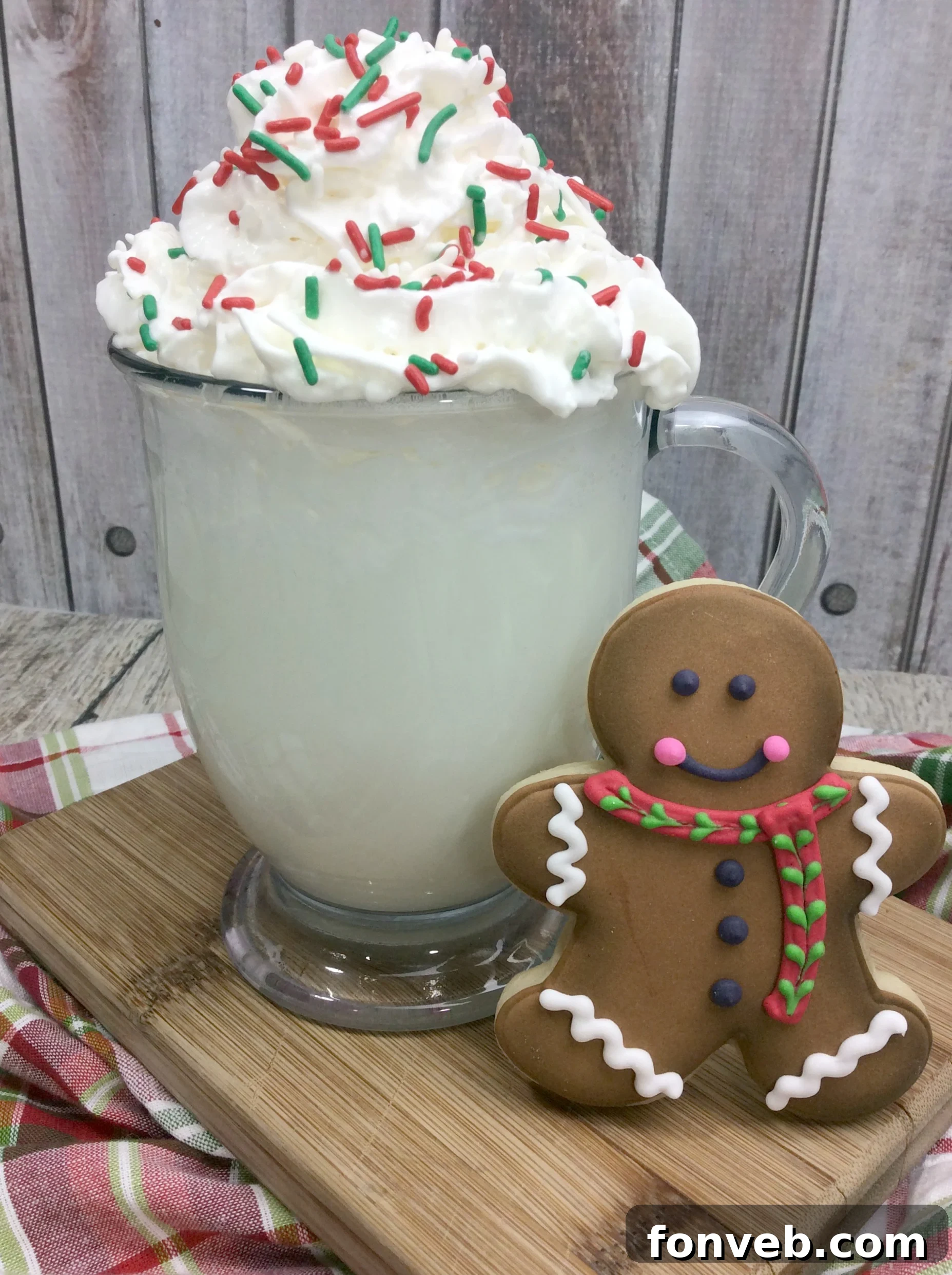 A warm mug of homemade Starbucks Sugar Cookie Hot Cocoa topped with fluffy whipped cream and colorful sprinkles, embodying a cozy winter treat.