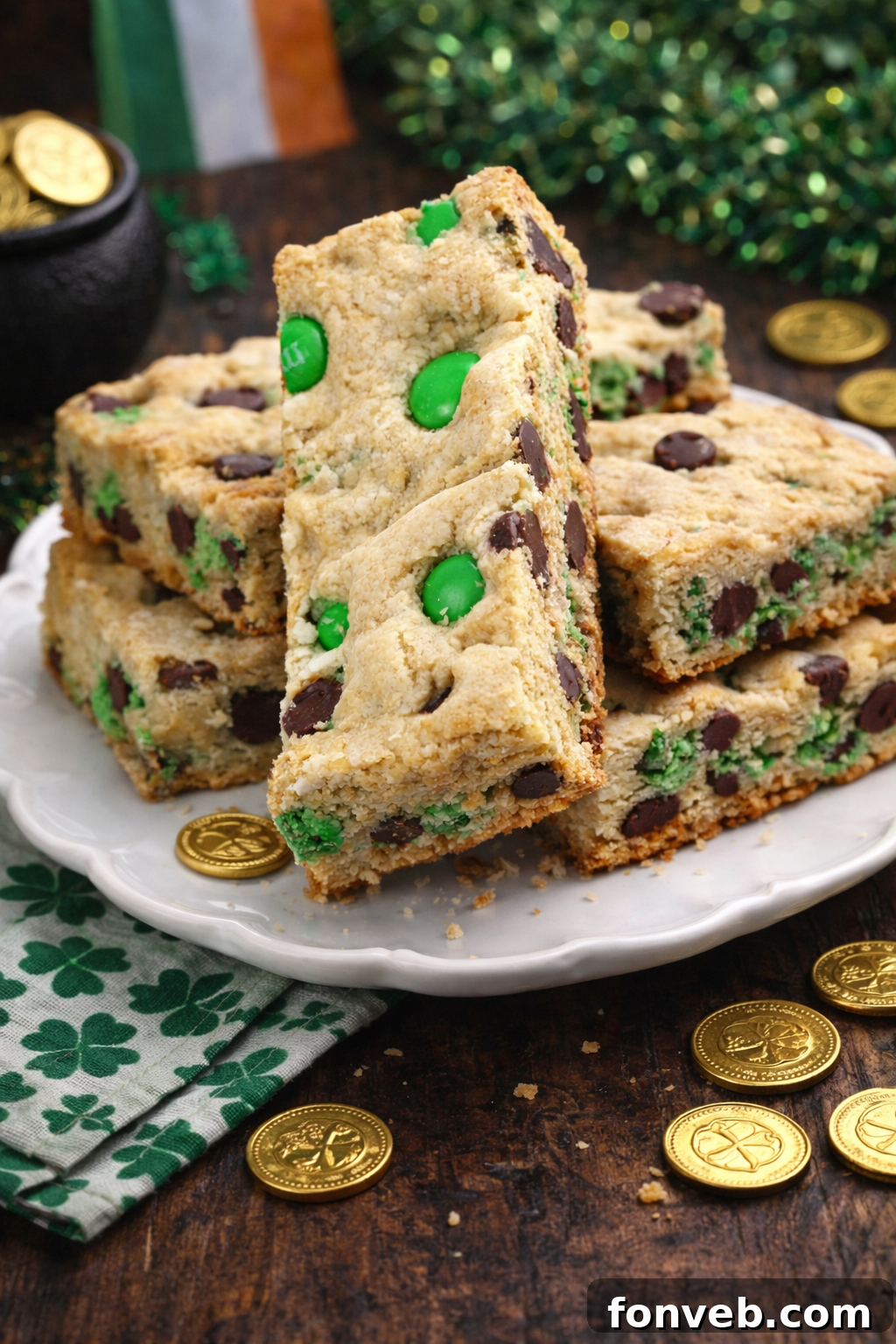 Lucky Shamrock Chocolate Chip Cookie Bars 2 Saint Patrick's Day Chocolate Chip Cookie Bars on a white plate with St. Paddy's Day decor