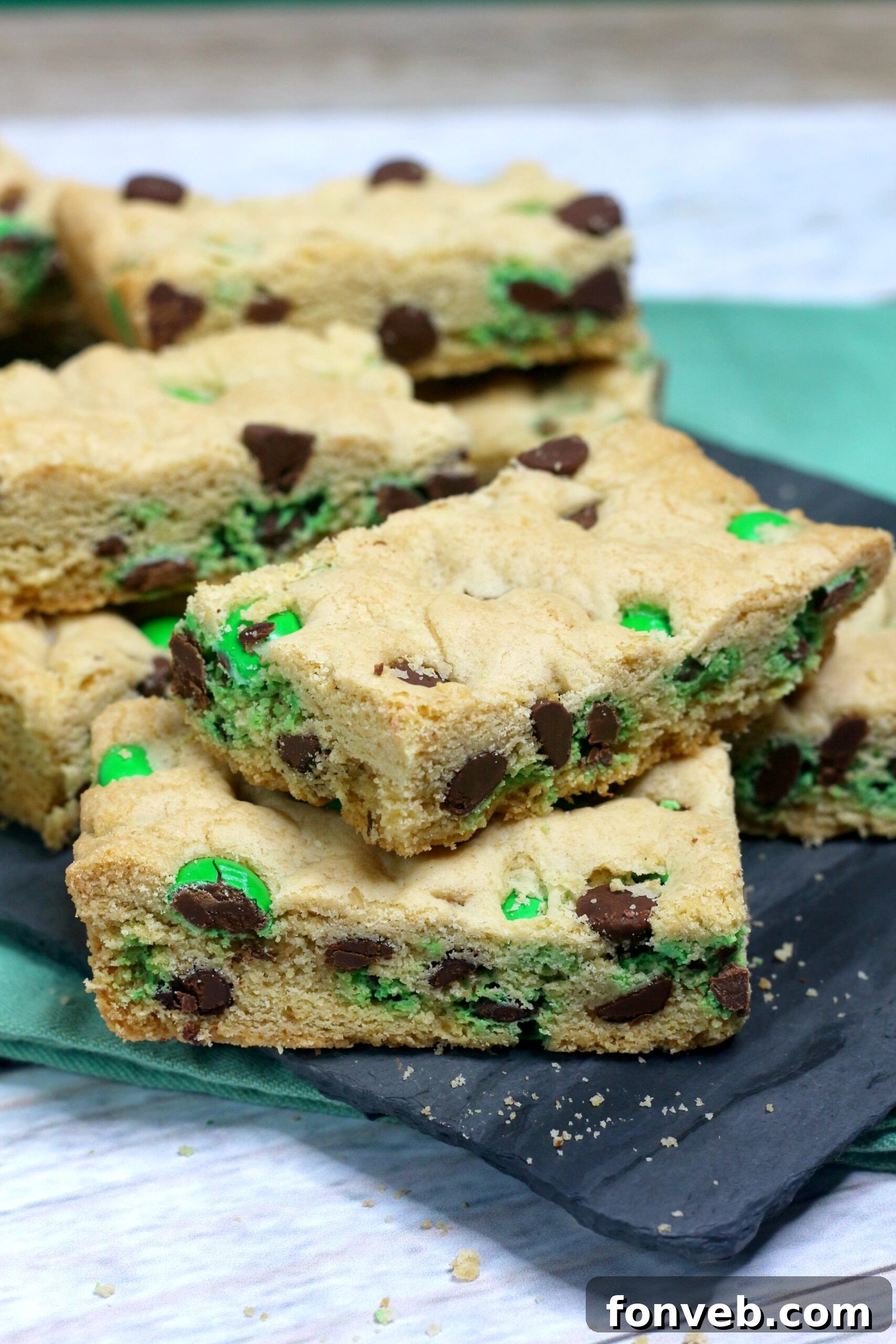 Lucky Shamrock Chocolate Chip Cookie Bars 4 Close-up image of Saint Patrick's Day Chocolate Chip Cookie Bars on a black serving tray with festive St. Patrick's Day decor