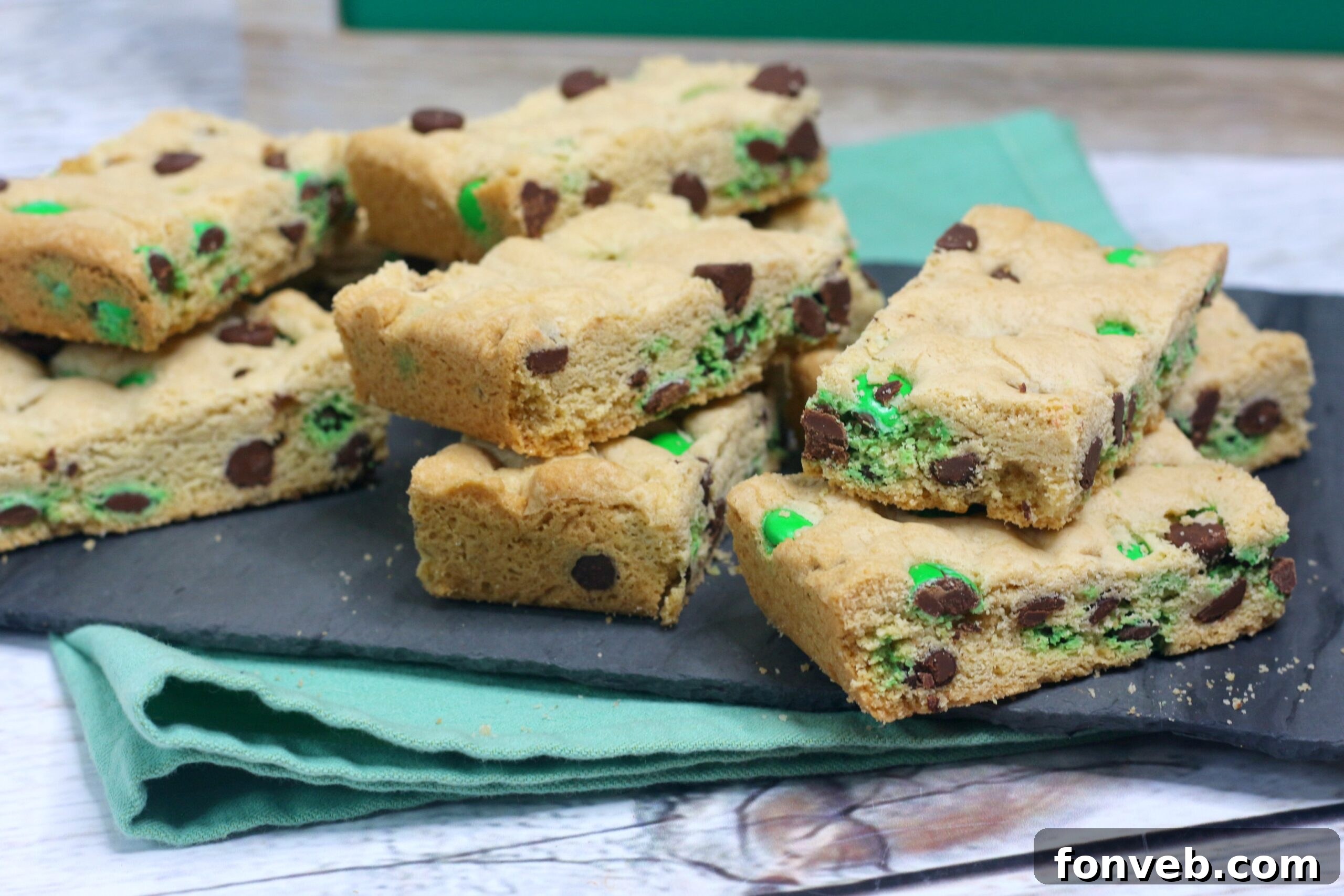 Lucky Shamrock Chocolate Chip Cookie Bars 6 St. Patrick's Day Chocolate Chip Cookie Bars on a black serving tray with festive St. Patrick's Day decor