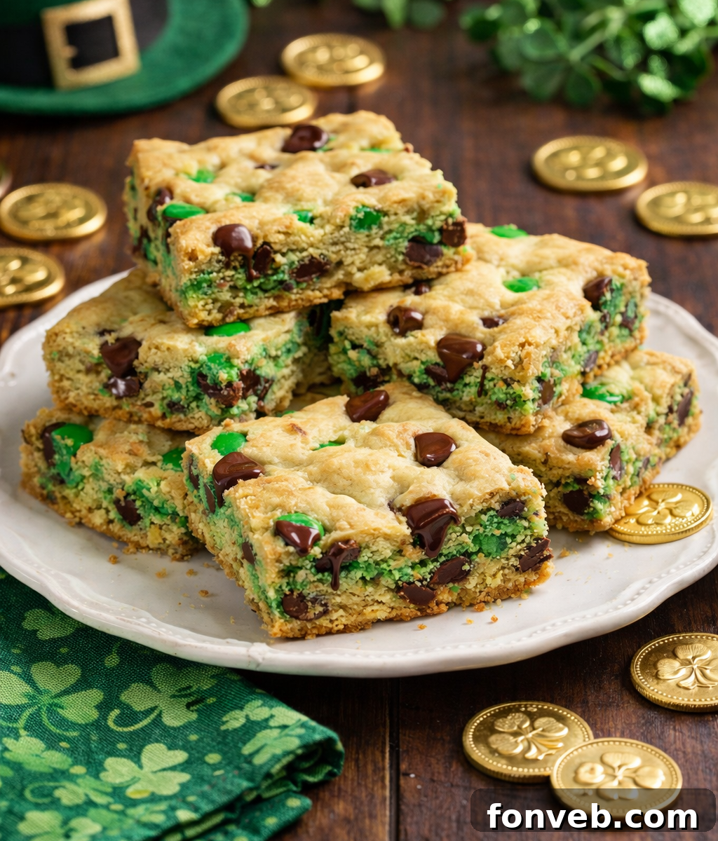 Lucky Shamrock Chocolate Chip Cookie Bars 7 Saint Patrick's Day Chocolate Chip Cookie Bars on a white plate with St. Patrick's Day decor and gold coins around them