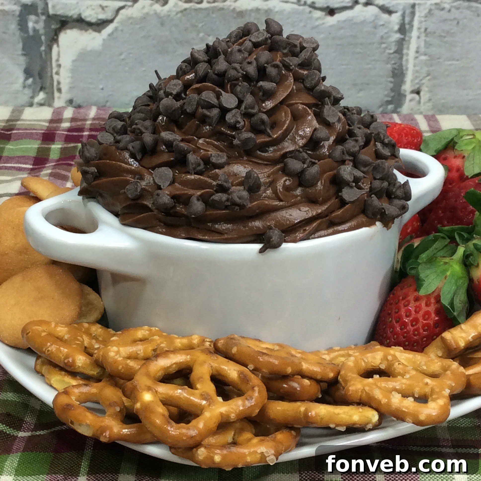 Assortment of dippers like pretzels, Nilla wafers, and graham crackers alongside a bowl of creamy Brownie Batter Dip