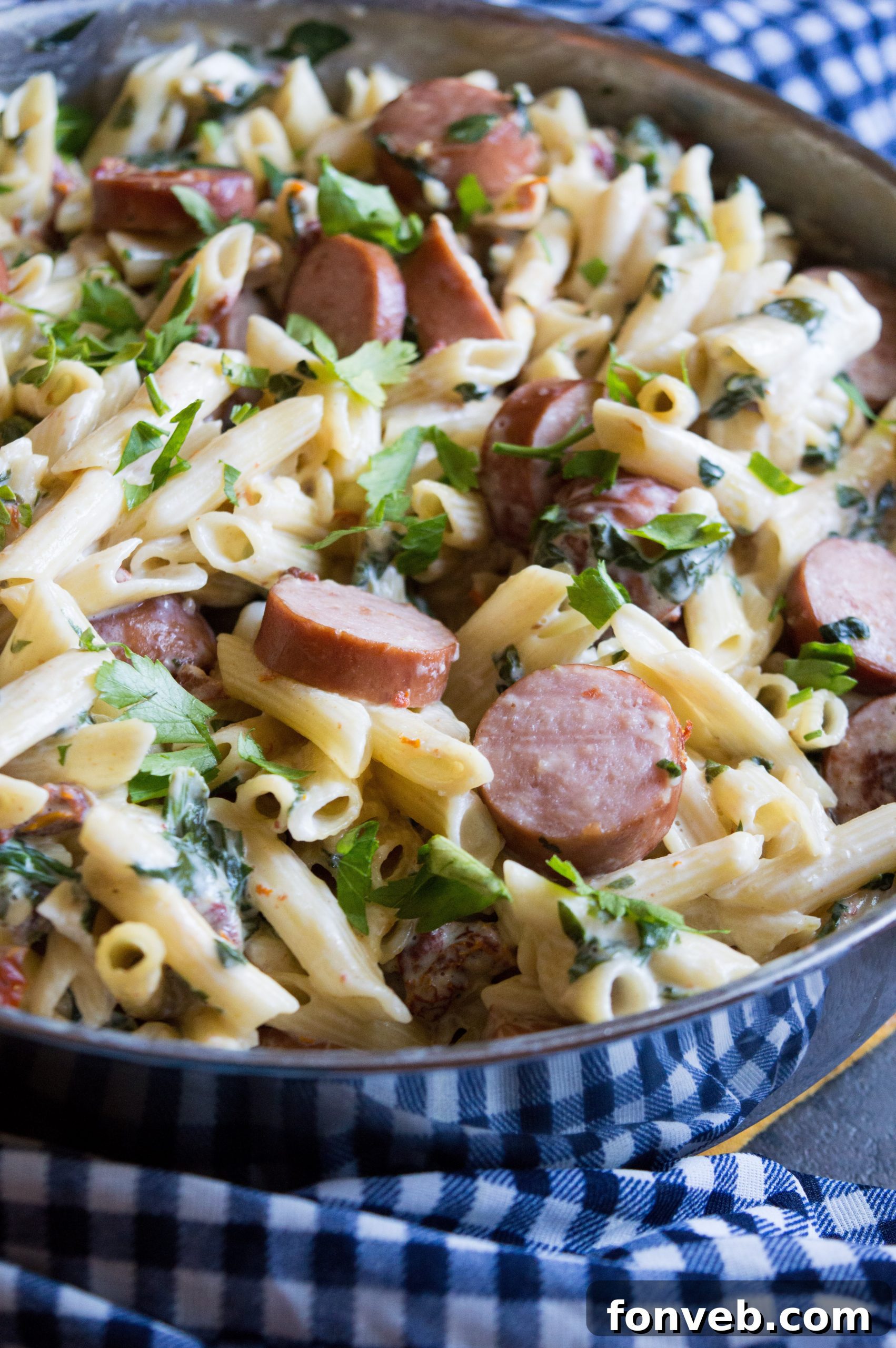 Luscious Garlic Mozzarella Pasta with Spinach and Sausage 2 Creamy Mozzarella Pasta with Spinach and Sausage, garnished with fresh herbs