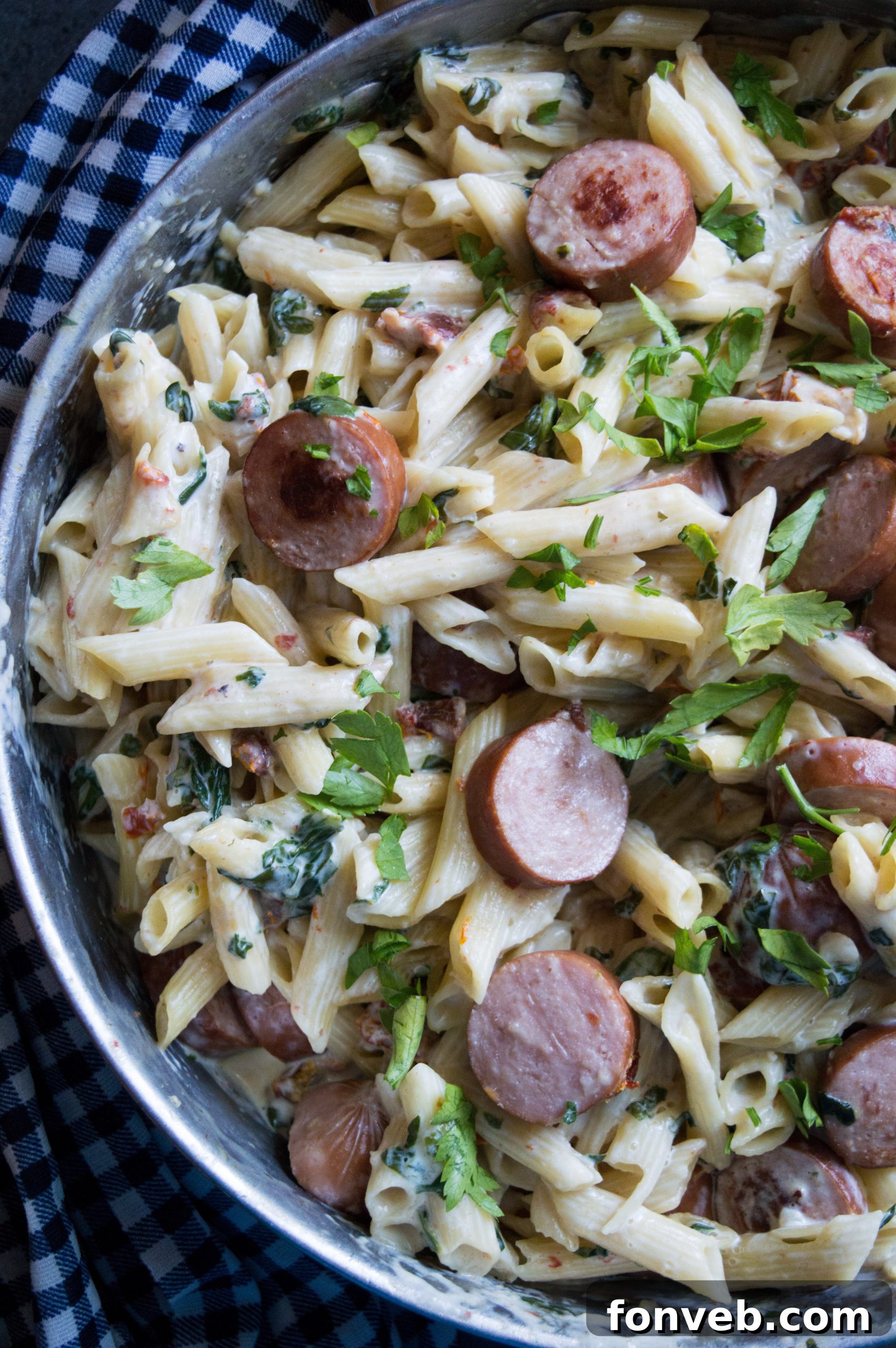 Luscious Garlic Mozzarella Pasta with Spinach and Sausage 10 Overhead shot of the Creamy Mozzarella Pasta dish, showcasing the abundance of sauce and ingredients
