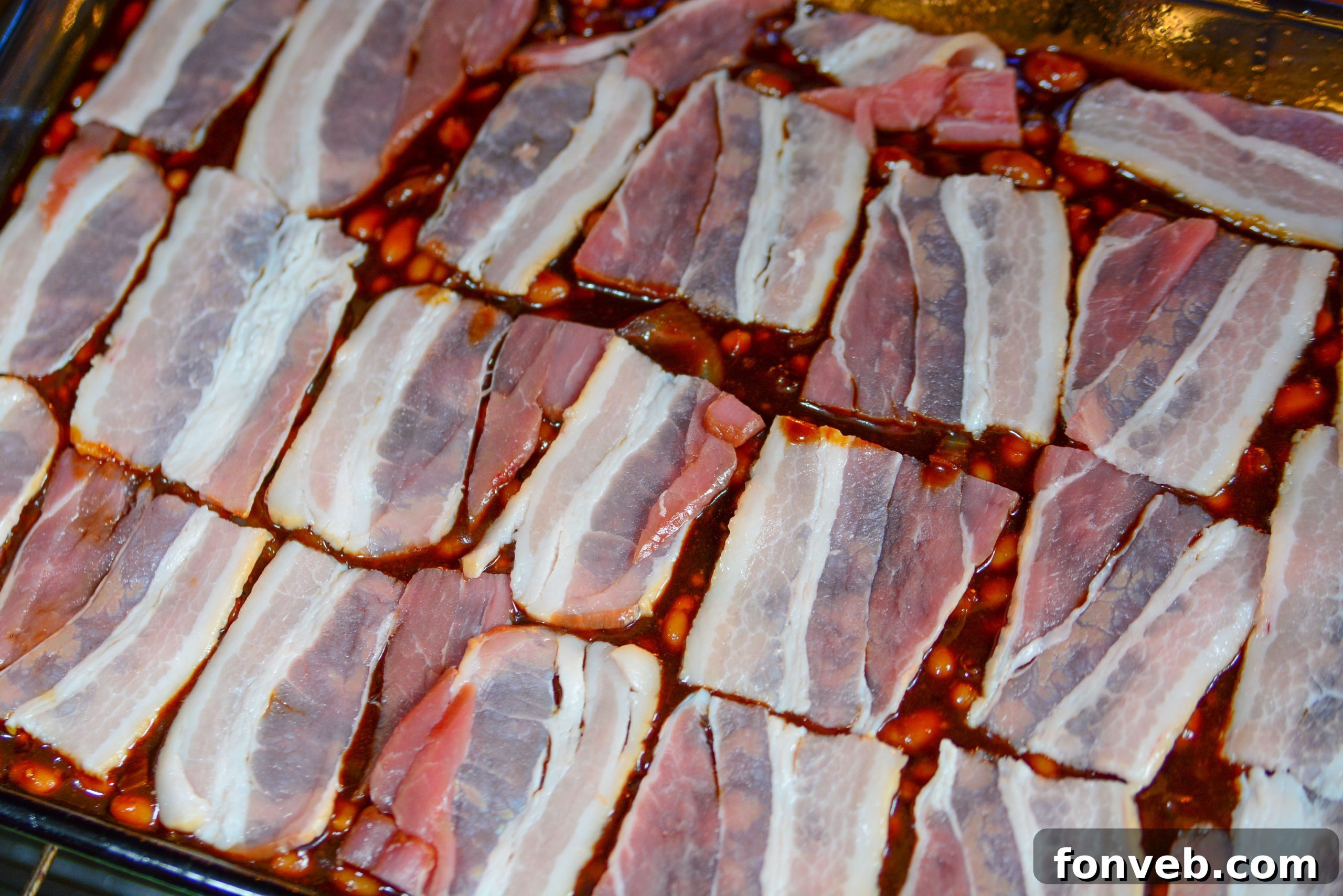 Brown Sugar Bacon Baked Beans in a baking dish uncooked