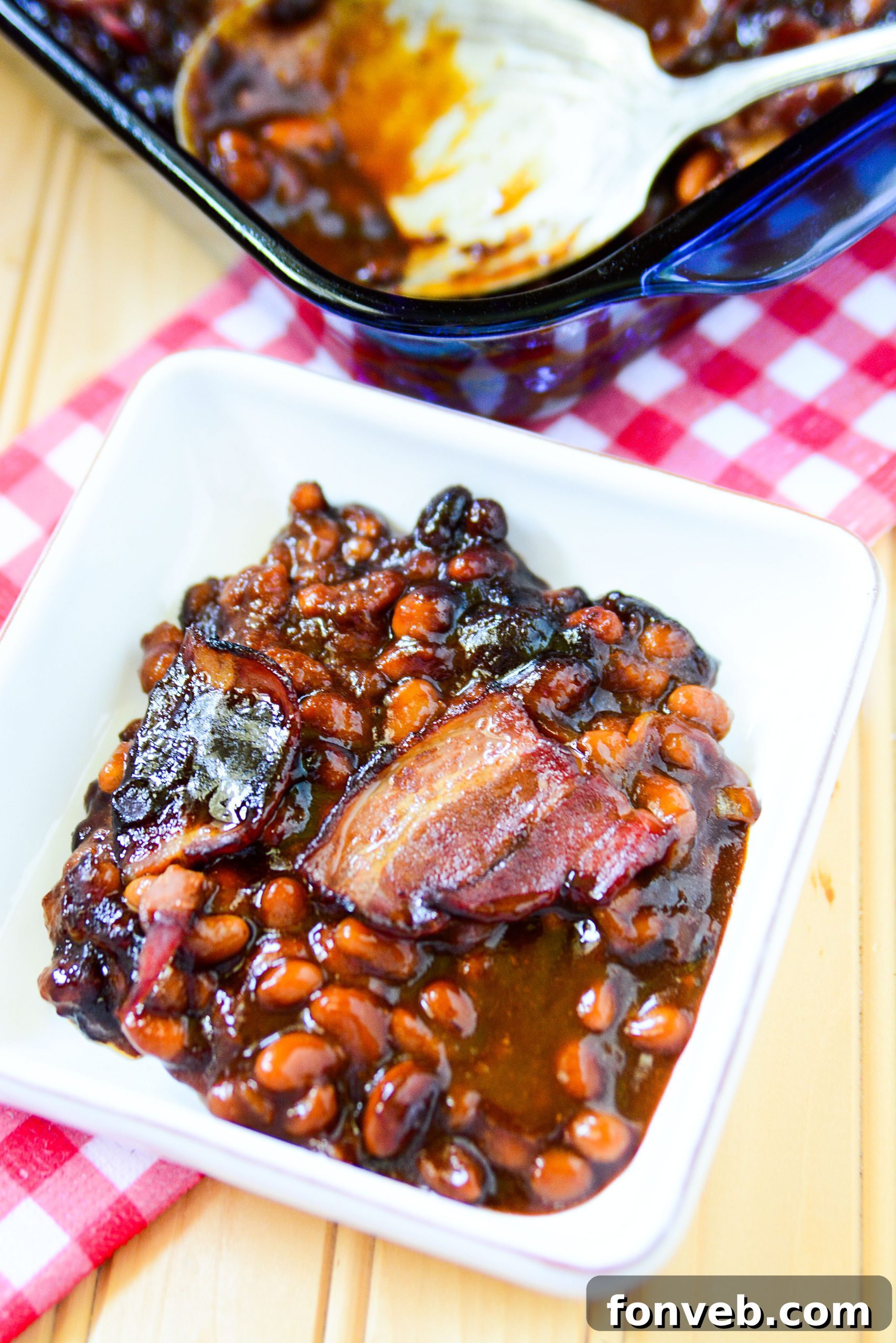 Brown Sugar Bacon Baked Beans in a white bowl up close