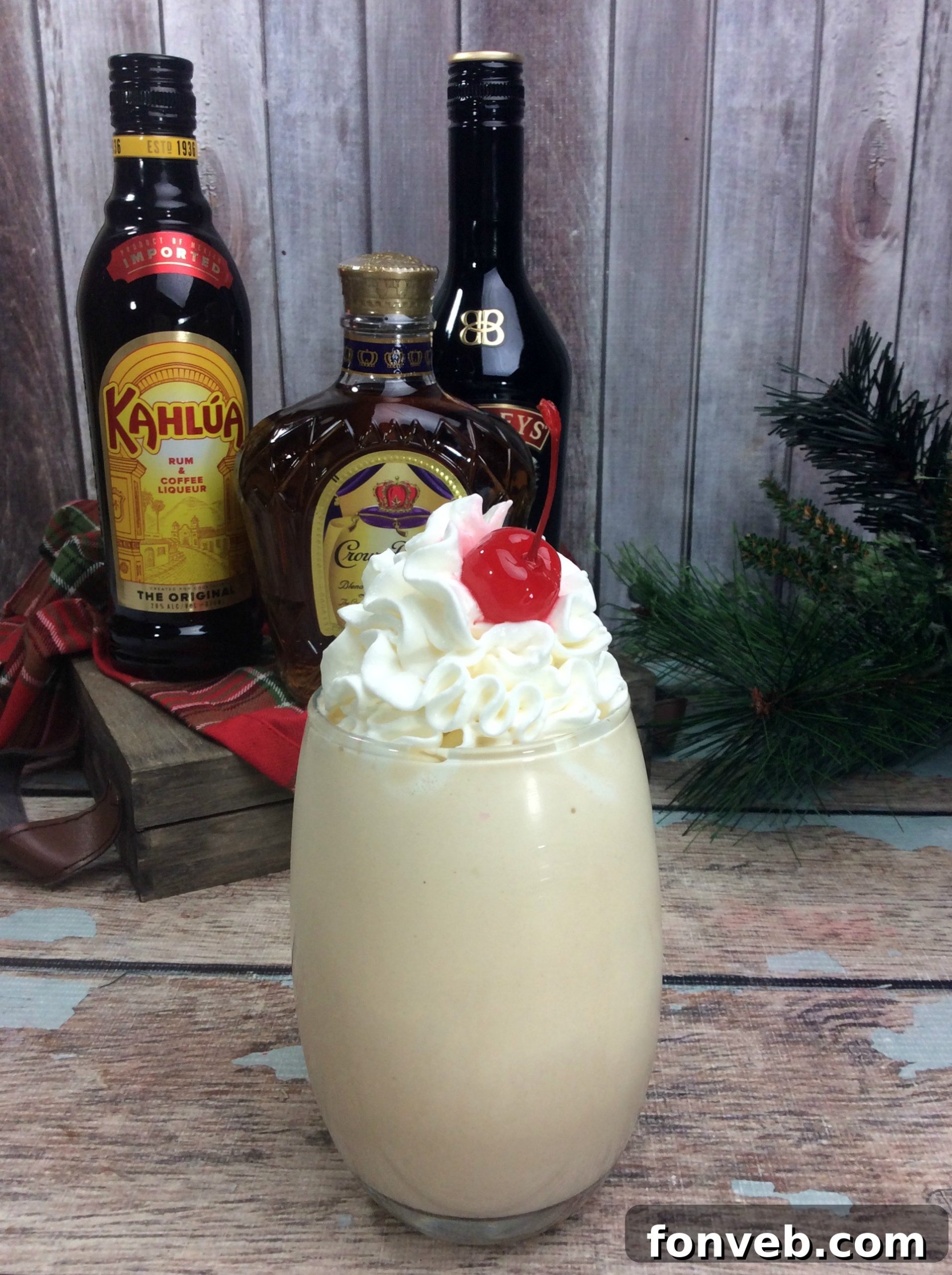 An inviting close-up of the Alaska Duck Fart Cocktail, showcasing the vibrant cherry and swirl of whipped cream.