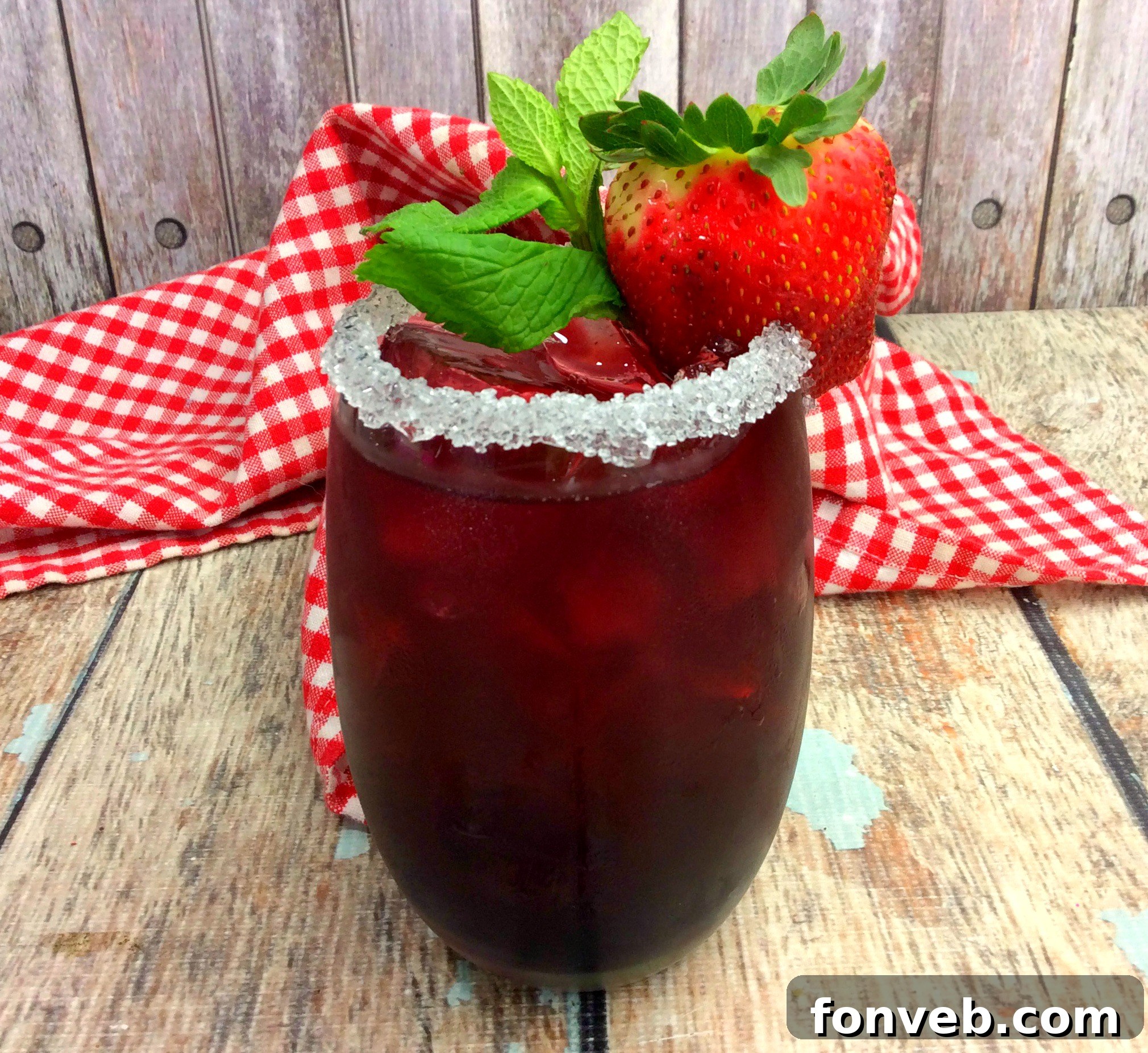 Ingredients for Tickle Me Strawberry Triple Crown Cocktail laid out including bourbon, strawberries, mint, and lemonade.