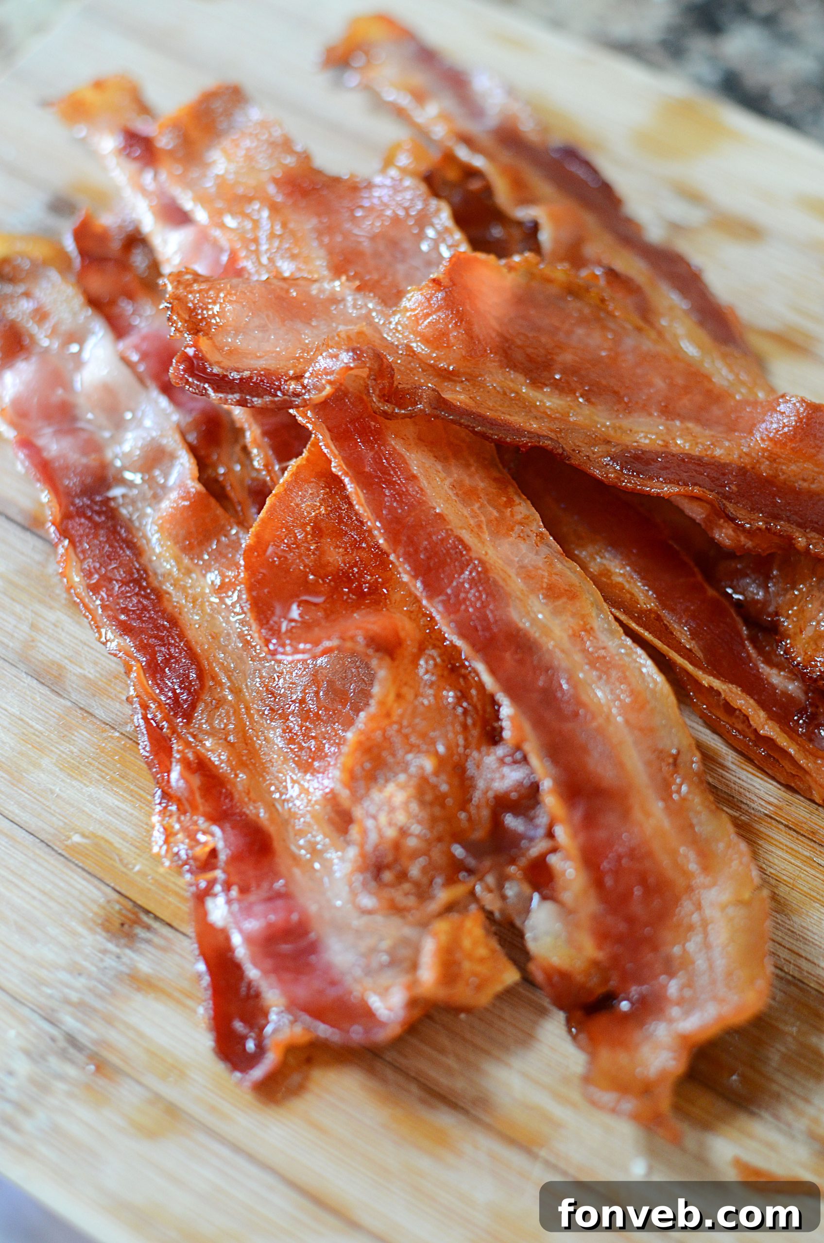 Perfectly baked bacon strips laid out on a baking sheet before cooking