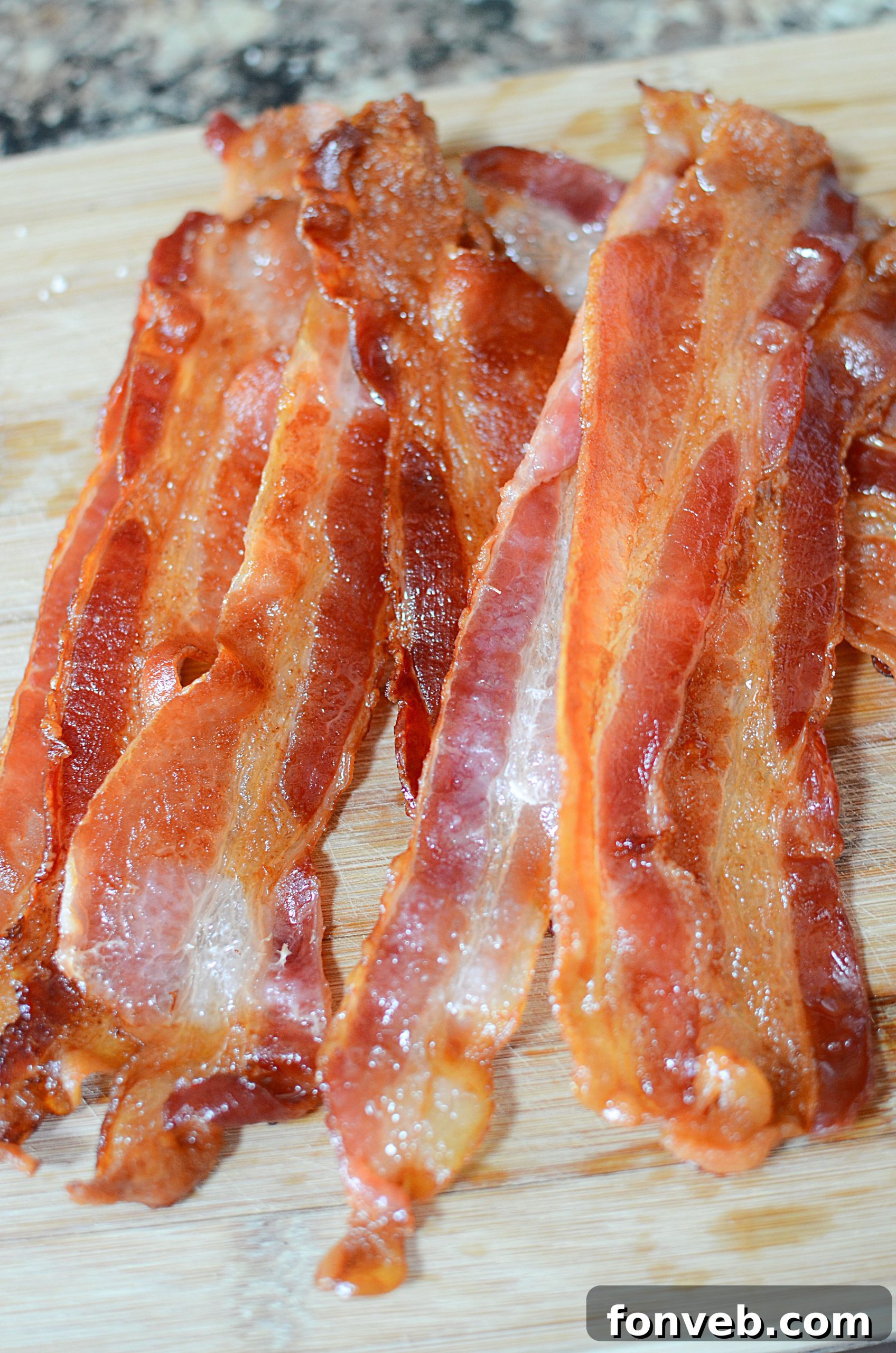 Cooked bacon slices fresh out of the oven, golden and crispy
