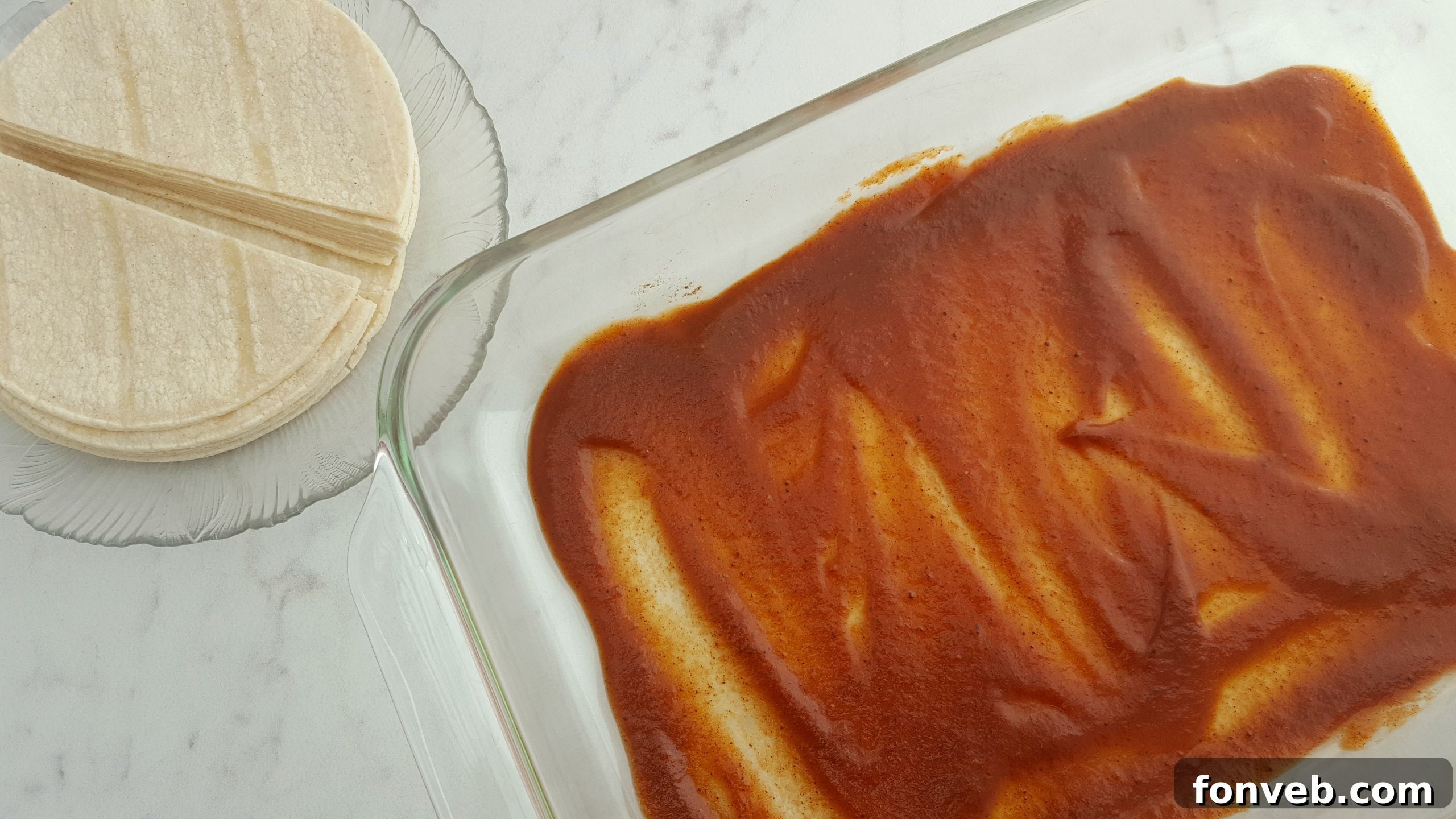 Layering tortillas in a casserole dish for Mexican Lasagna.