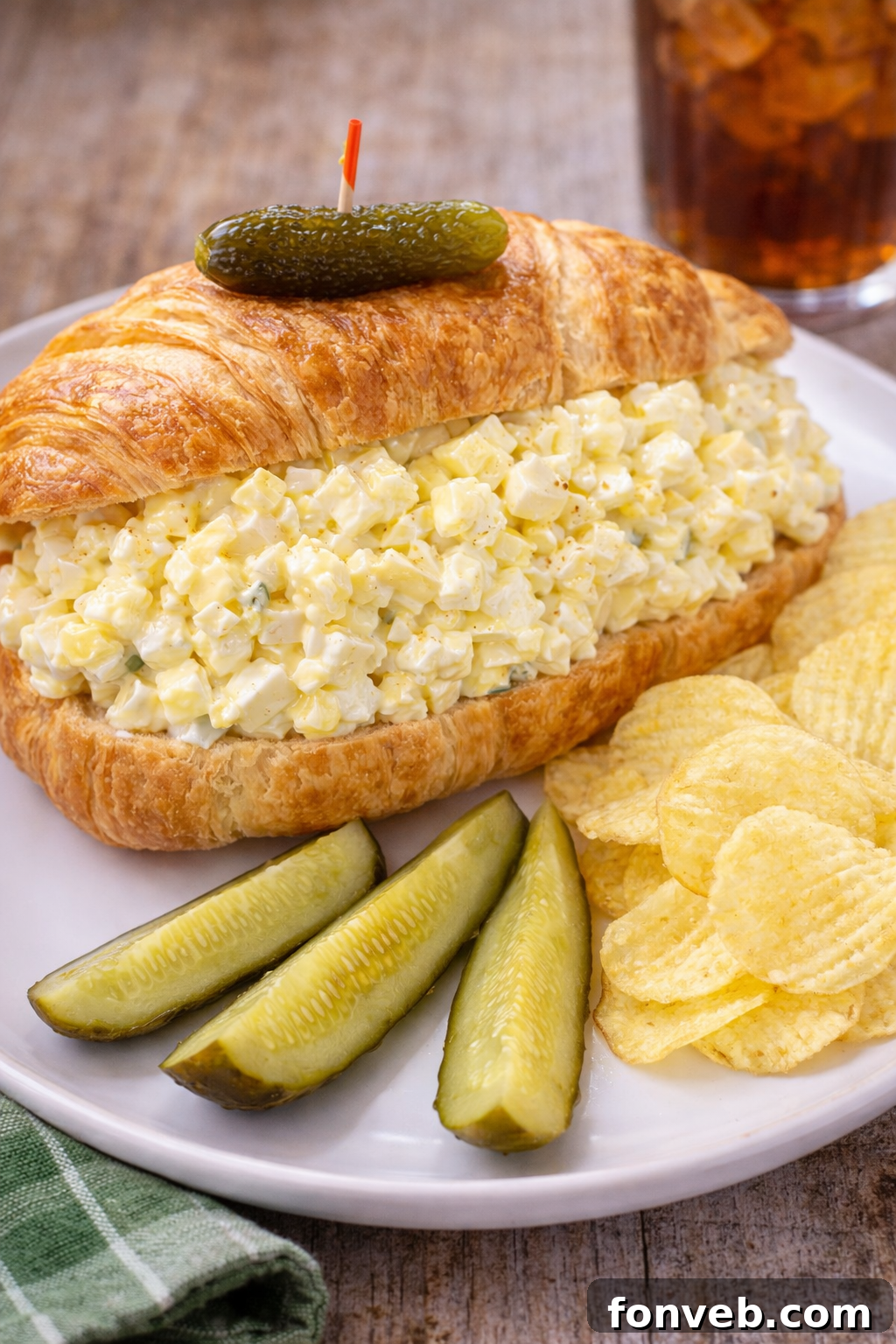 A serving of the ultimate creamy egg salad, garnished with fresh herbs.