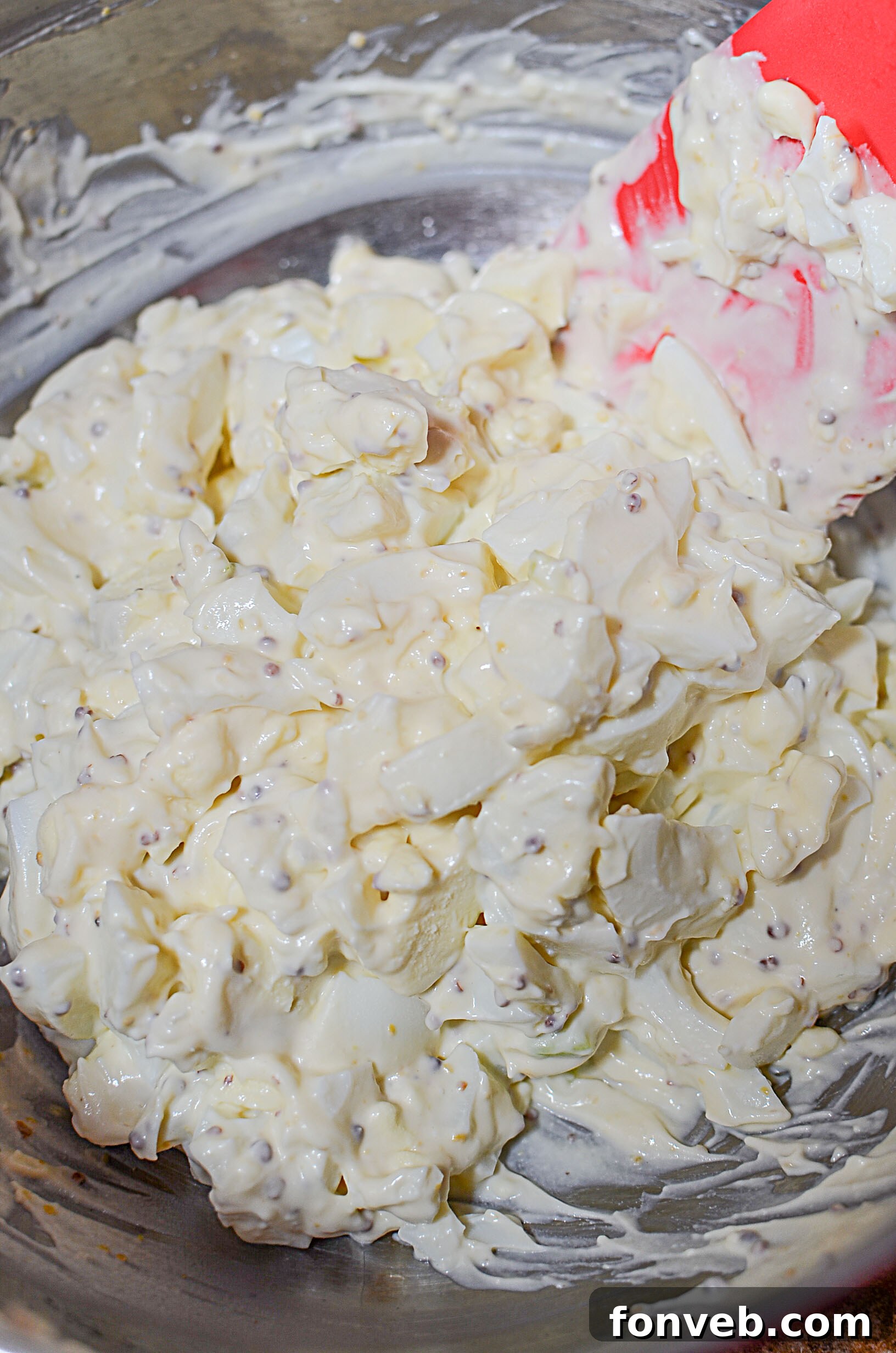 A bowl of the ultimate egg salad, showing its creamy texture and fine ingredients.