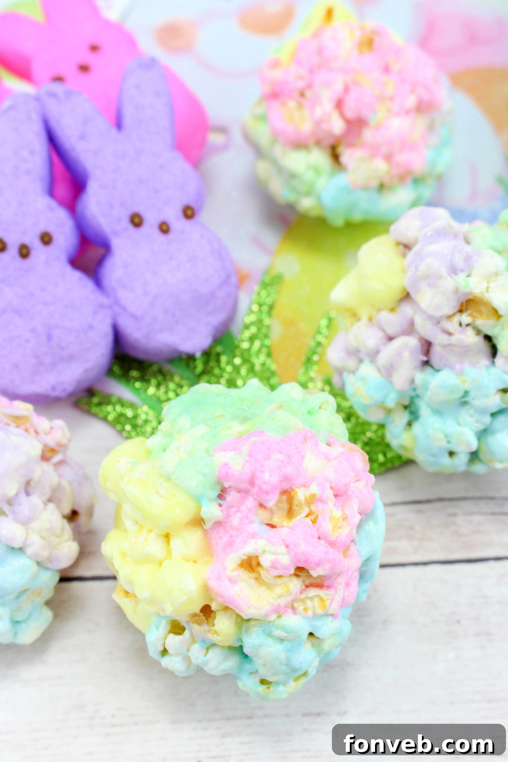 Colorful Marshmallow Popcorn Balls arranged beautifully on a serving tray, showcasing vibrant spring colors, perfect for an Easter gathering.