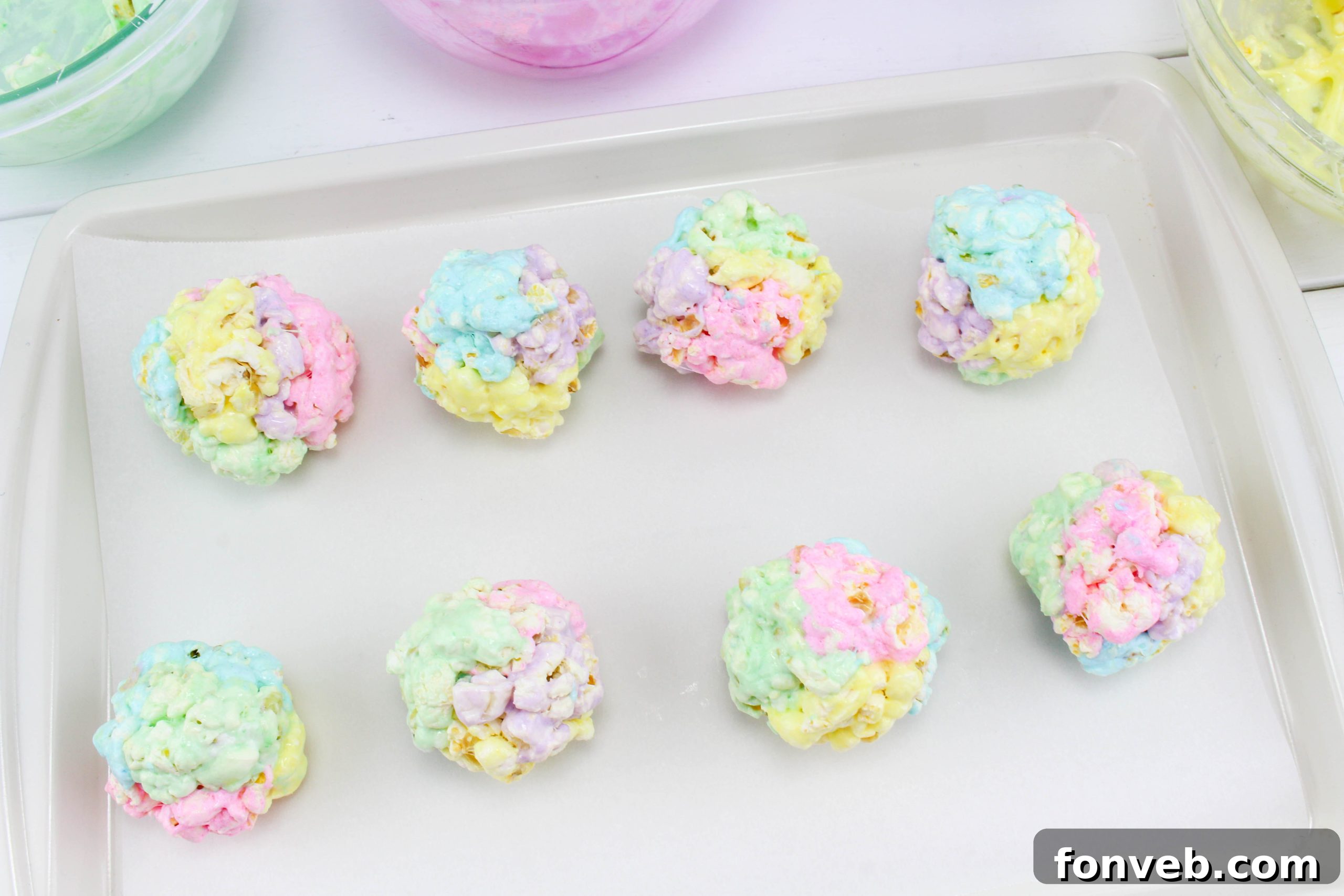 A vibrant display of freshly made marshmallow popcorn balls, showcasing their varied textures and inviting appearance, ready to be enjoyed.