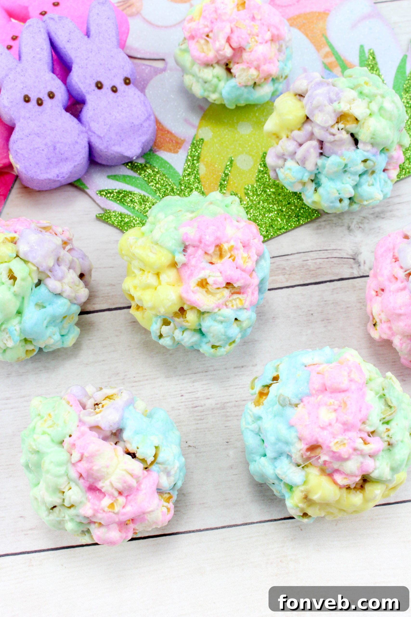 A beautifully arranged collection of finished marshmallow popcorn balls, showcasing the attractive swirls of color and inviting textures, on a simple background.