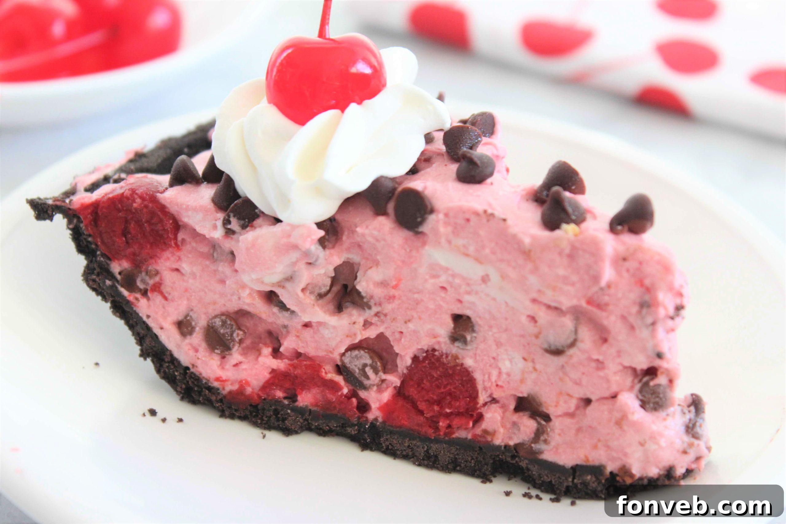 Overhead shot of the finished No-Bake Cherry Creamsicle Pie with a few slices already cut, showing the full pie.