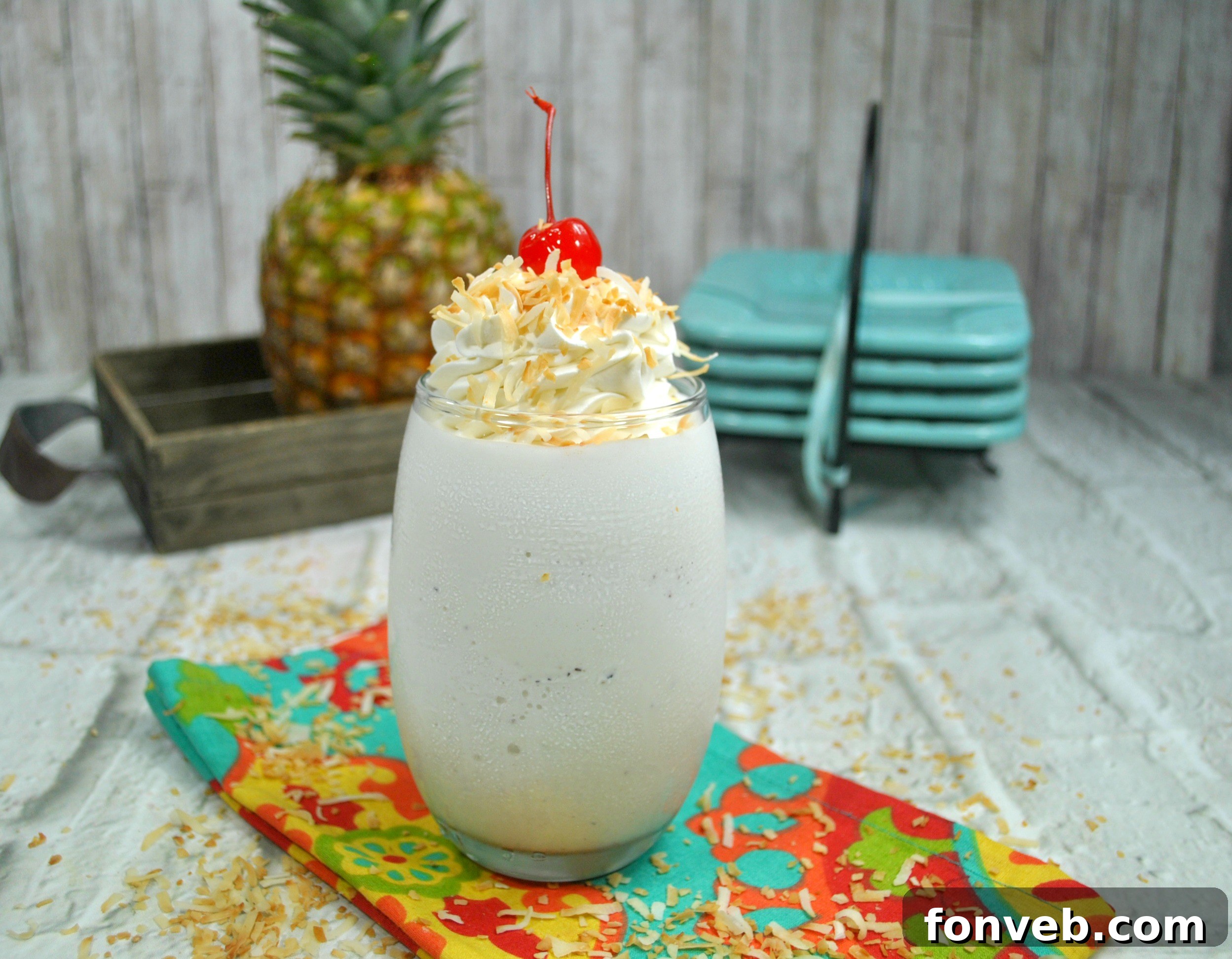 Collection of Pina Colada ingredients laid out on a table: cream of coconut, pineapple juice, various rums, ice, and garnishes