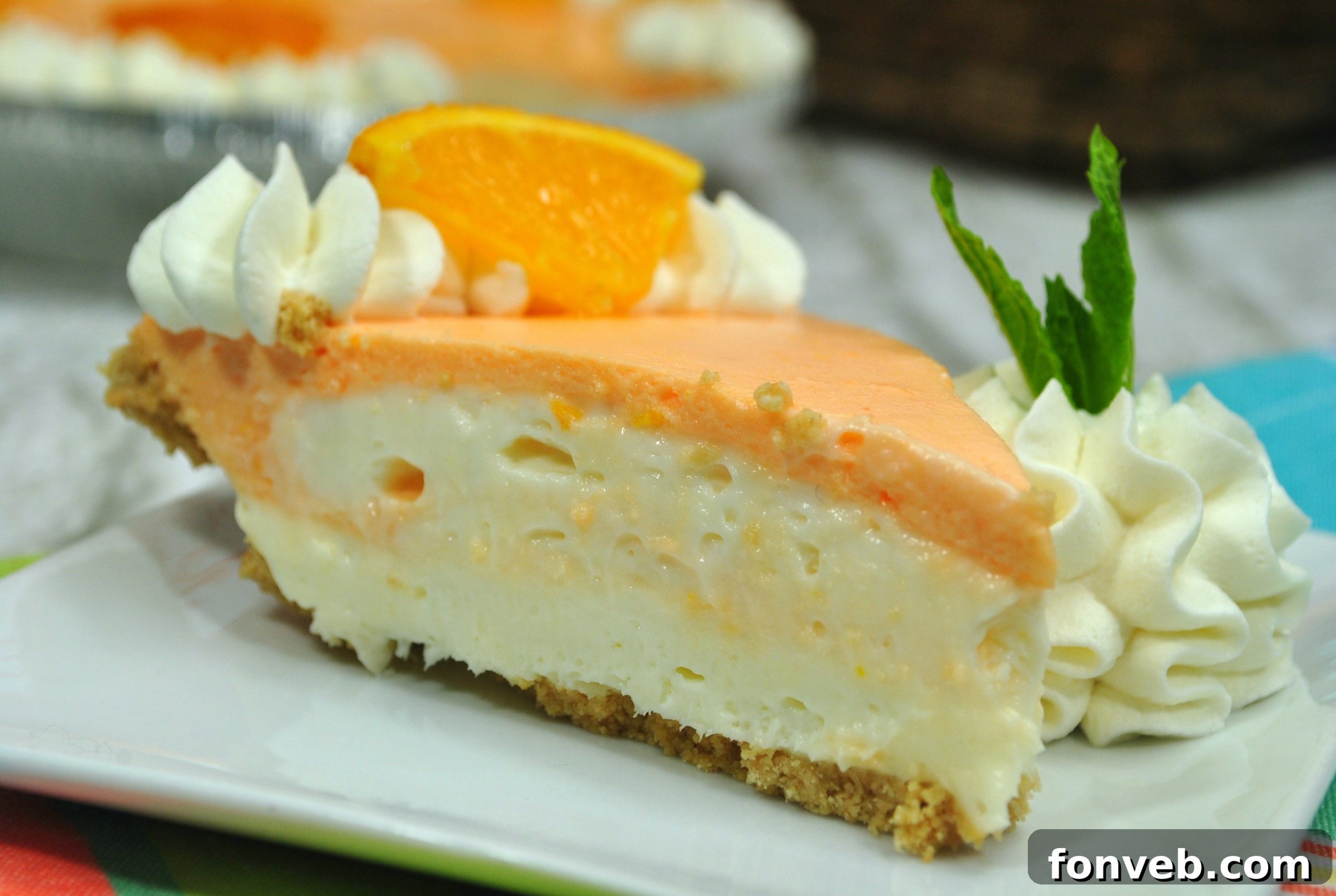 Close-up shot of Orange Creamsicle Cheesecake showing creamy layers