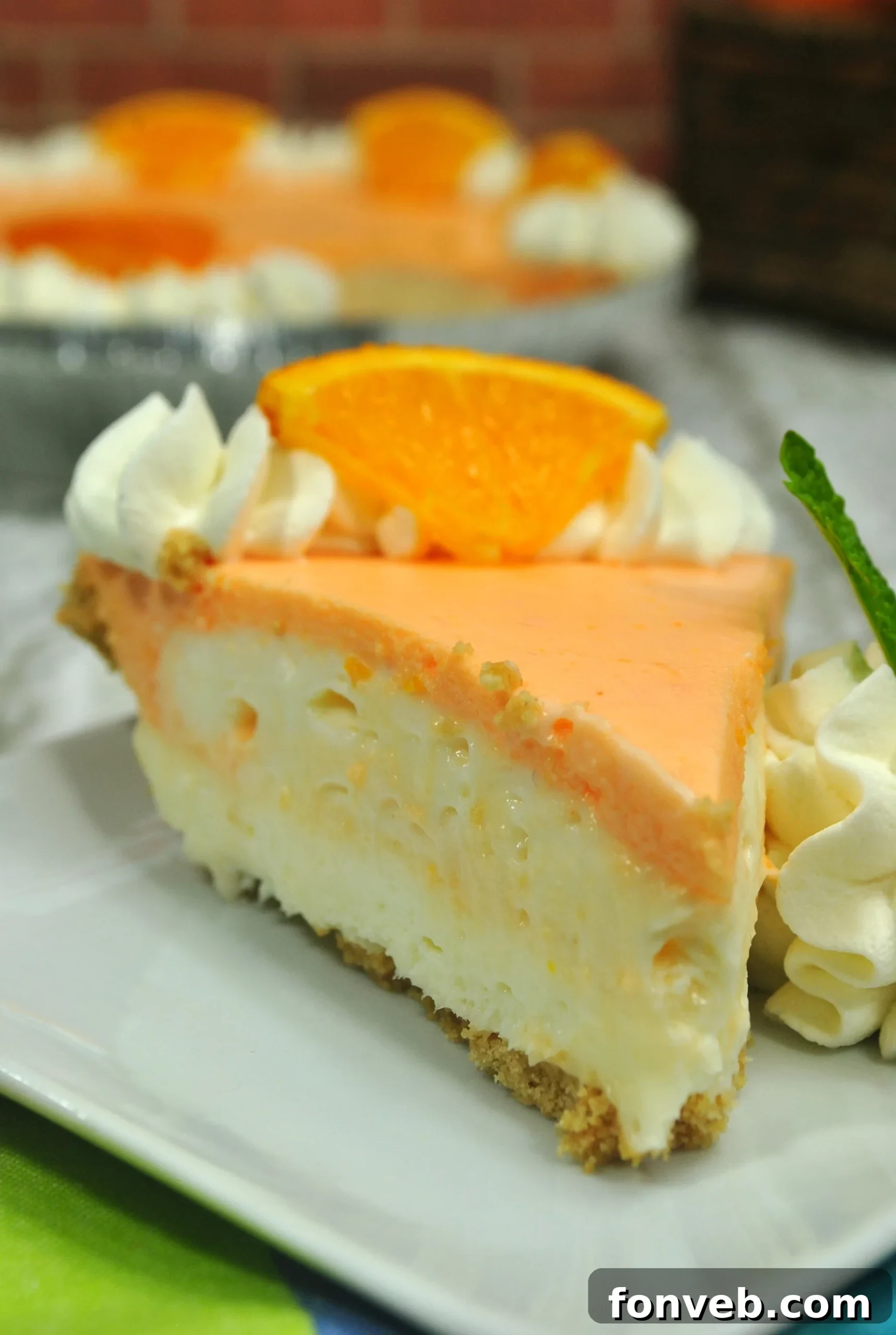 Finished Orange Creamsicle Cheesecake with piped cream topping
