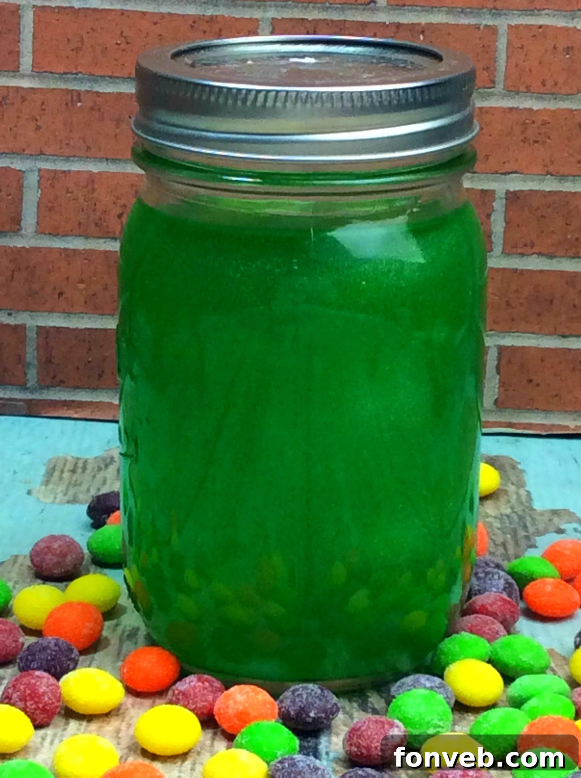 Assorted colors of Skittles candy ready for moonshine infusion, sorted into piles