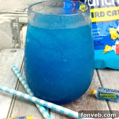 Blue Raspberry Jolly Rancher Cocktail with a candy rim