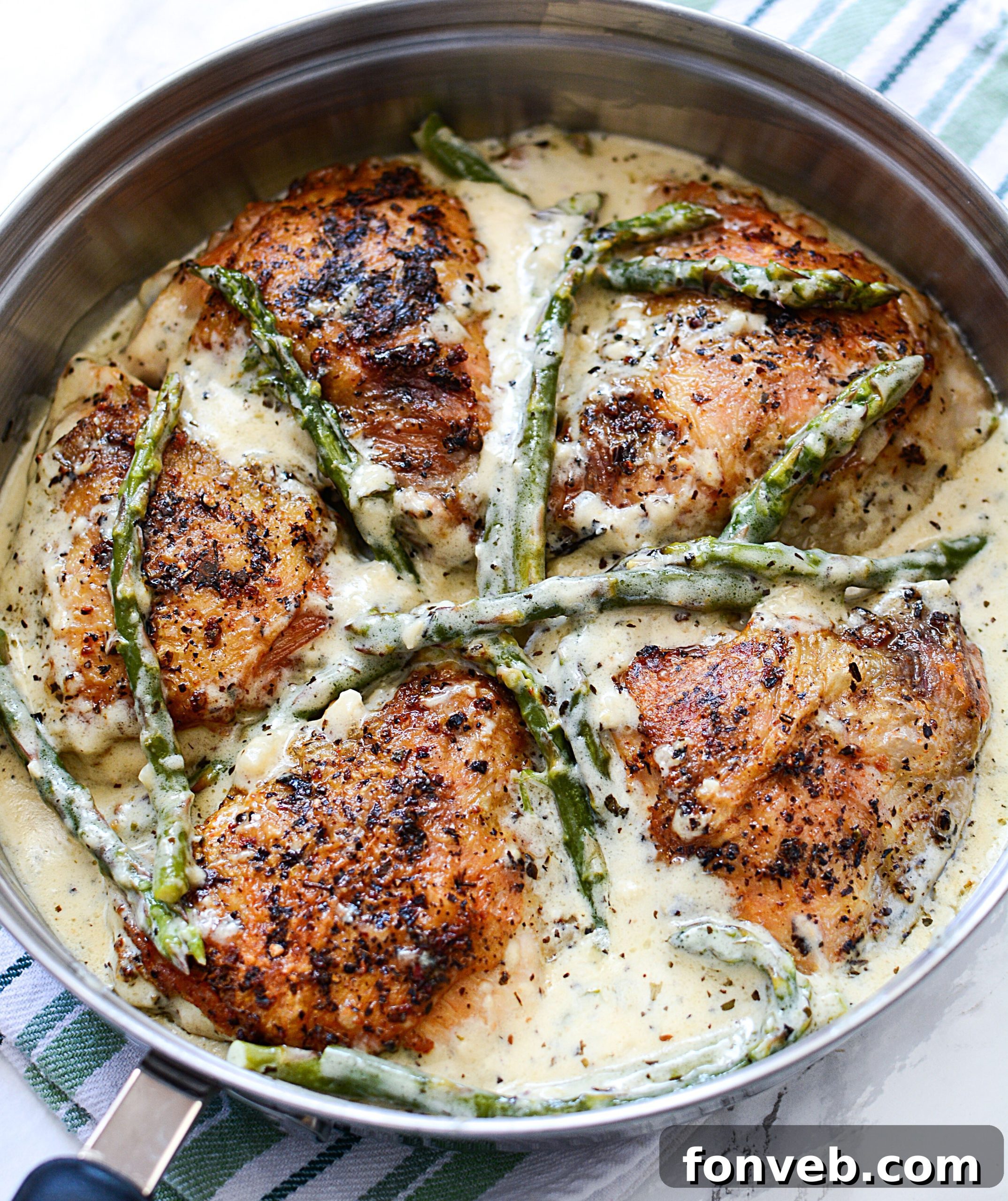 Golden-brown chicken thighs perfectly seared in a skillet for Creamy Garlic Dream Chicken
