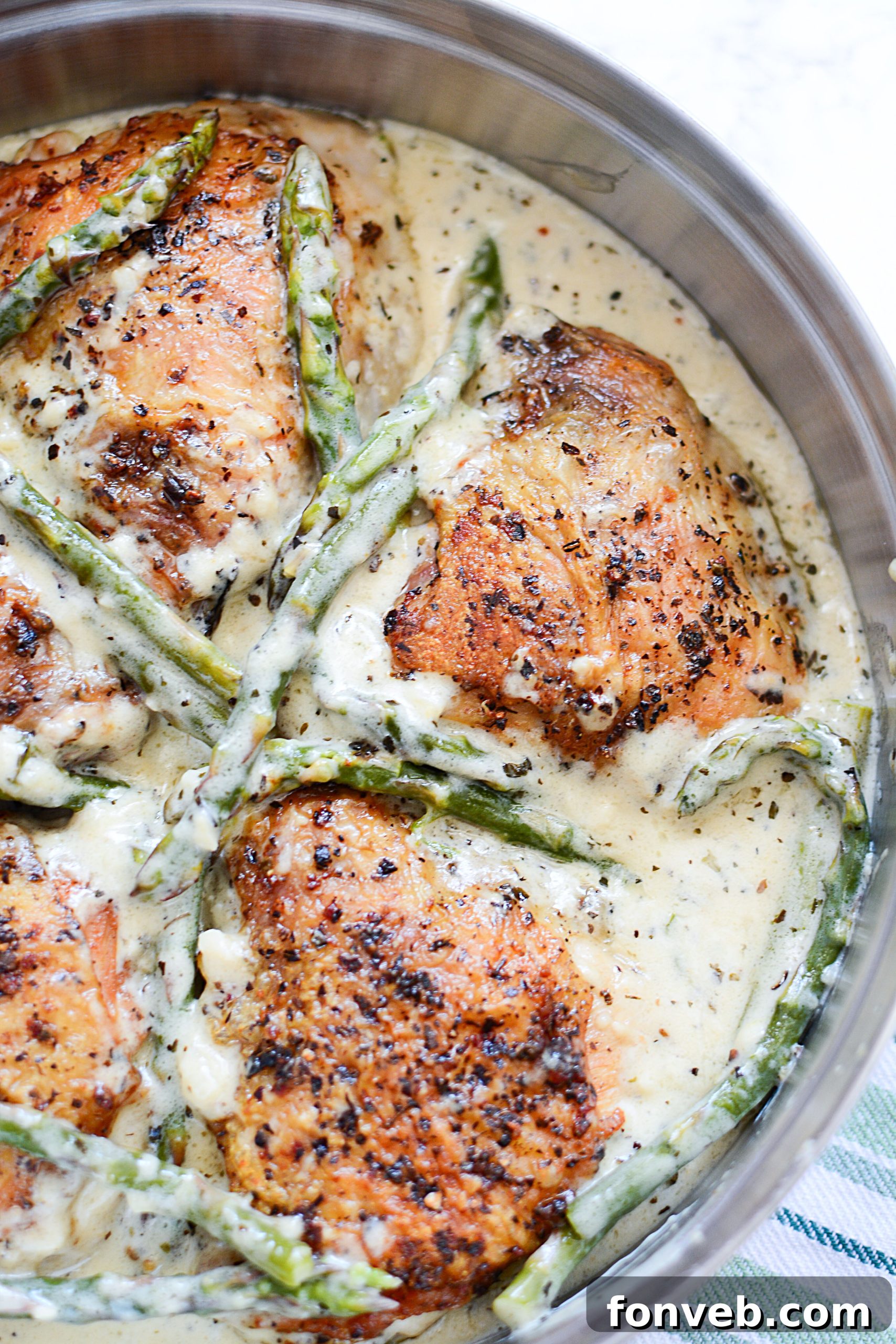 A serving of Creamy Garlic Dream Chicken with Asparagus, garnished with fresh parsley, ready to be enjoyed