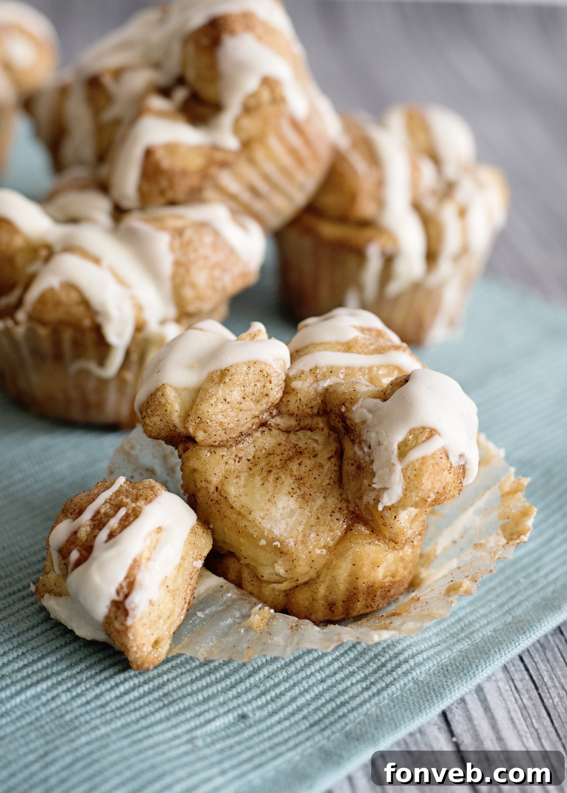Irresistible Snickerdoodle Pull-Apart Muffins 2 Freshly baked Snickerdoodle Monkey Bread Muffins in a muffin tin, golden brown and coated in cinnamon sugar.