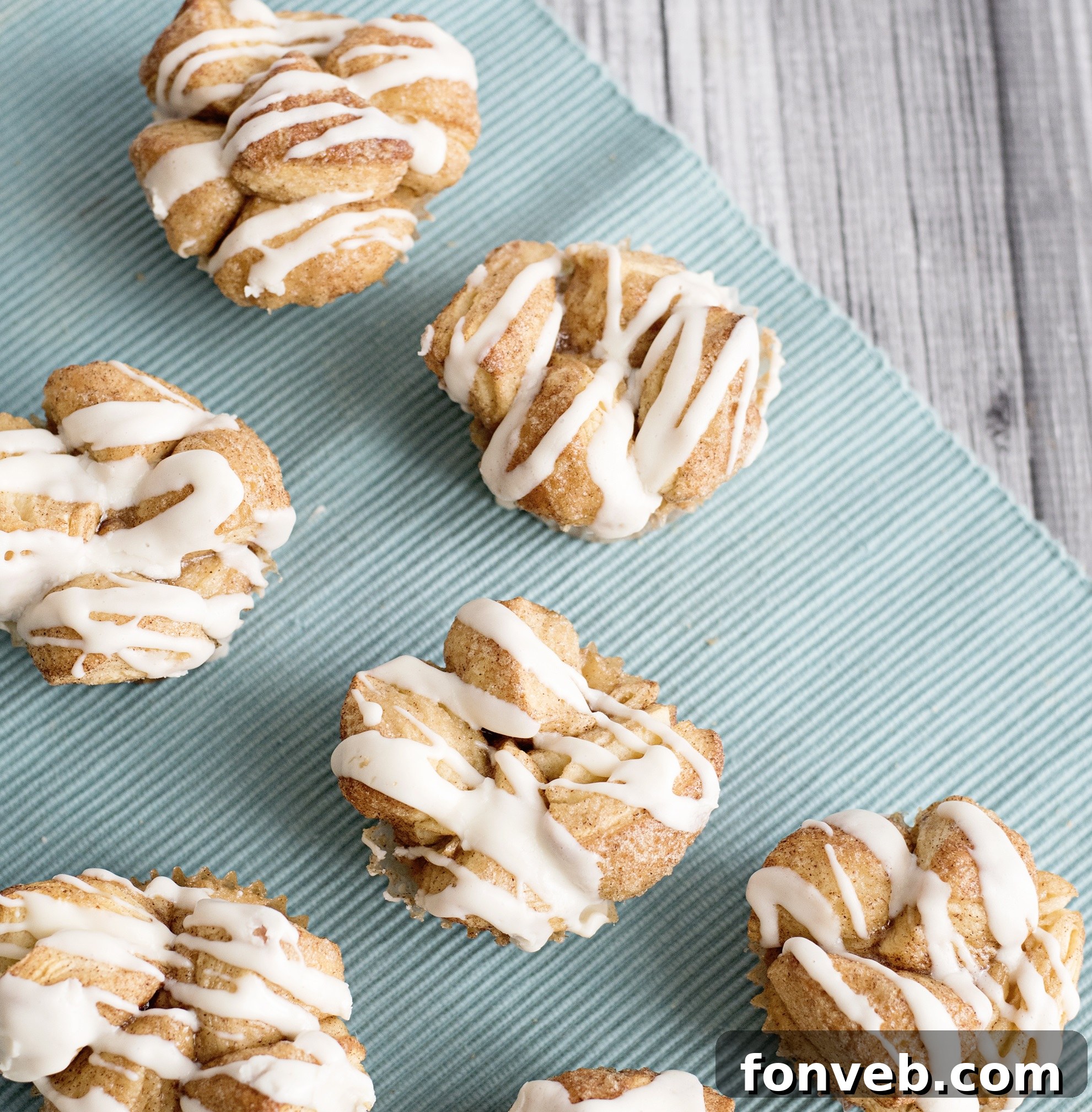 Irresistible Snickerdoodle Pull-Apart Muffins 6 Close-up of Snickerdoodle Monkey Bread Muffins with a delicate drizzle of cream cheese frosting.