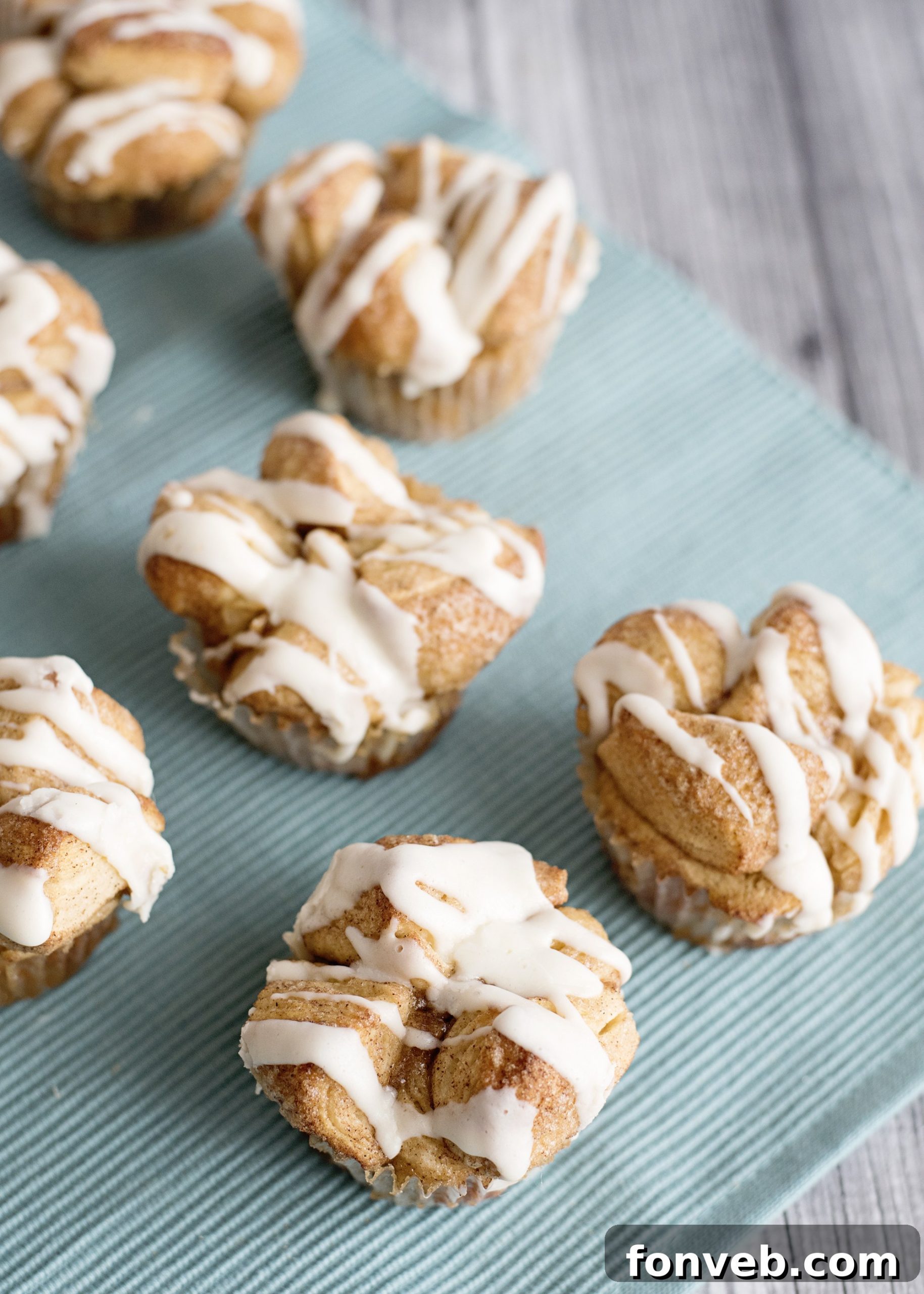 Irresistible Snickerdoodle Pull-Apart Muffins 7 A tray of Snickerdoodle Monkey Bread Muffins cooling after baking, showing their golden tops.