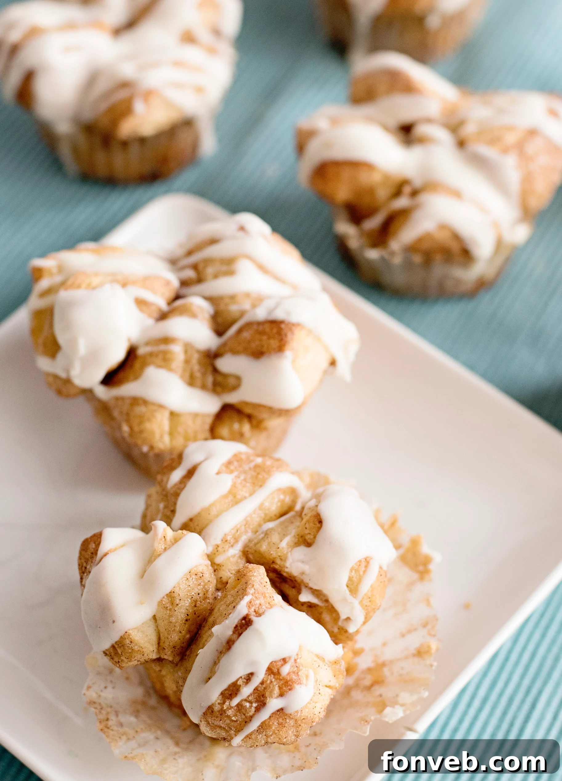 Irresistible Snickerdoodle Pull-Apart Muffins 8 A close-up shot of a Snickerdoodle Monkey Bread Muffin being pulled apart, revealing its soft, fluffy layers.