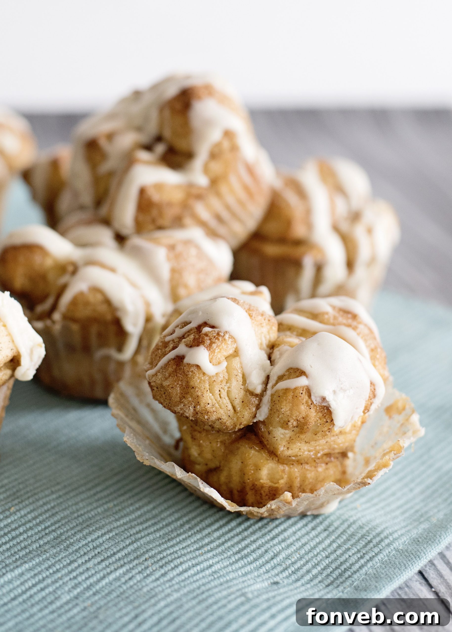 Irresistible Snickerdoodle Pull-Apart Muffins 9 A stack of Snickerdoodle Monkey Bread Muffins on a plate, ready to be served and enjoyed.