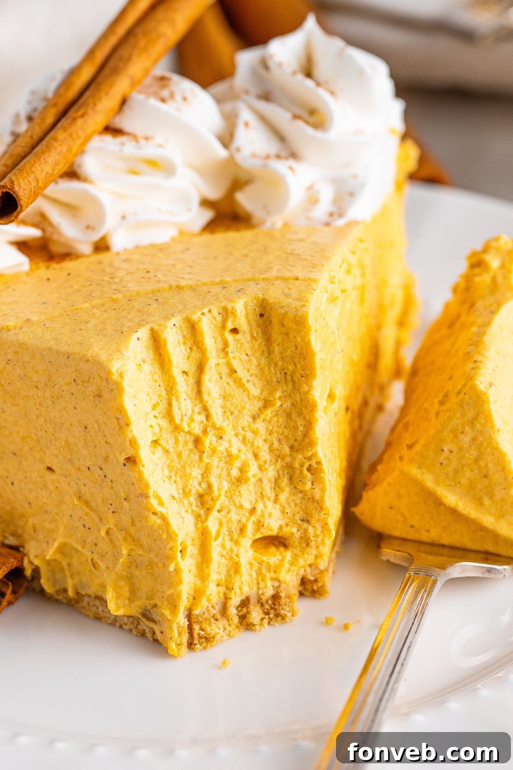 slice taken out of cheesecake on plate