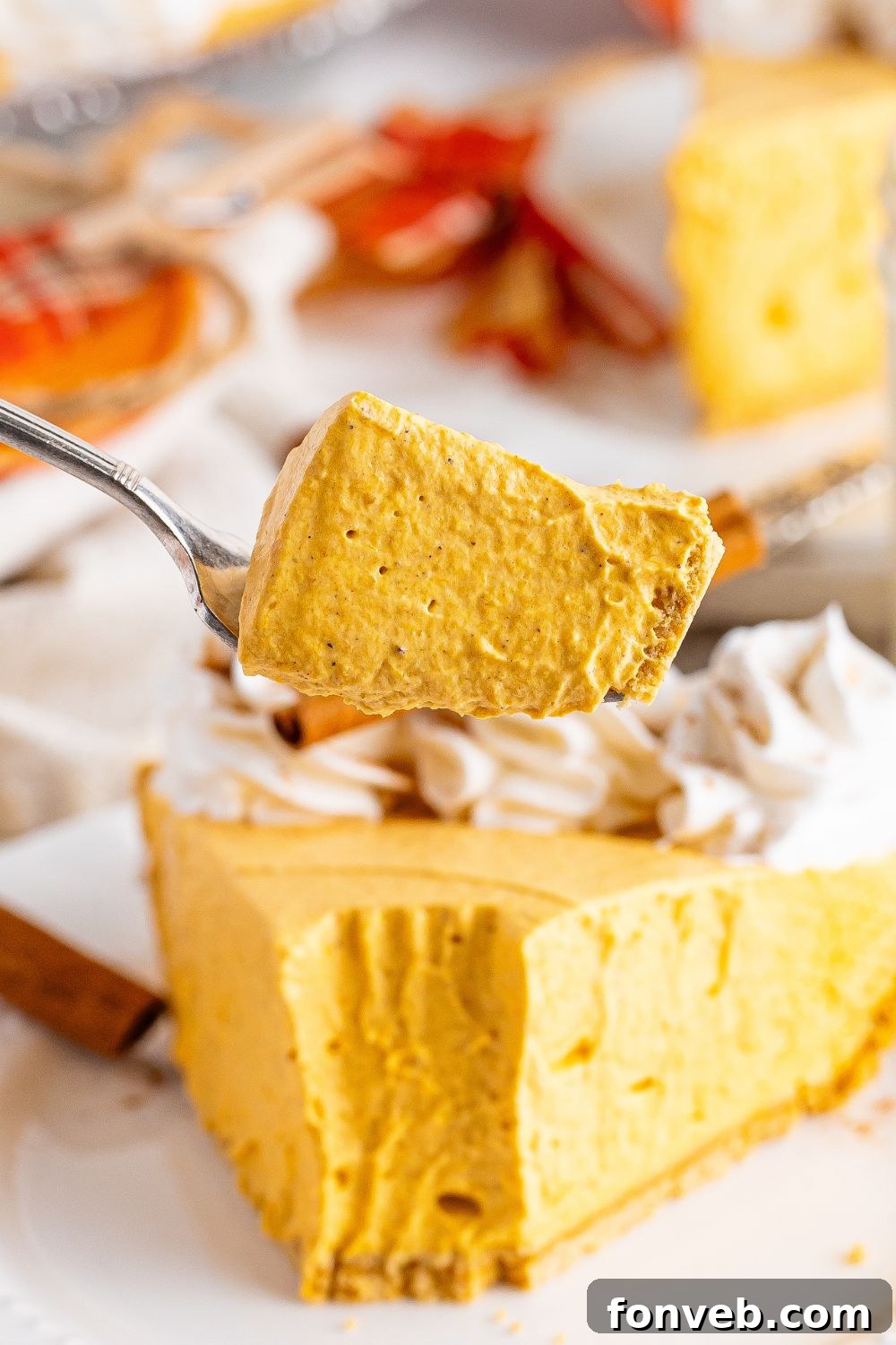 slice taken out of pumpkin cheesecake on plate