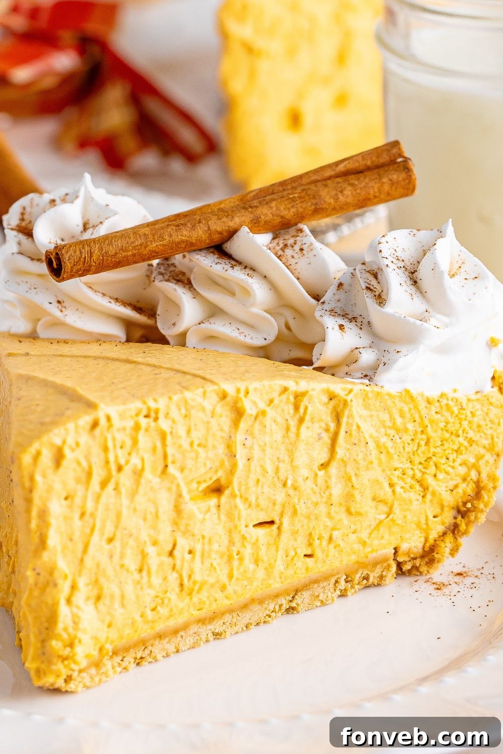 pumpkin spice cheesecake sliced on plate