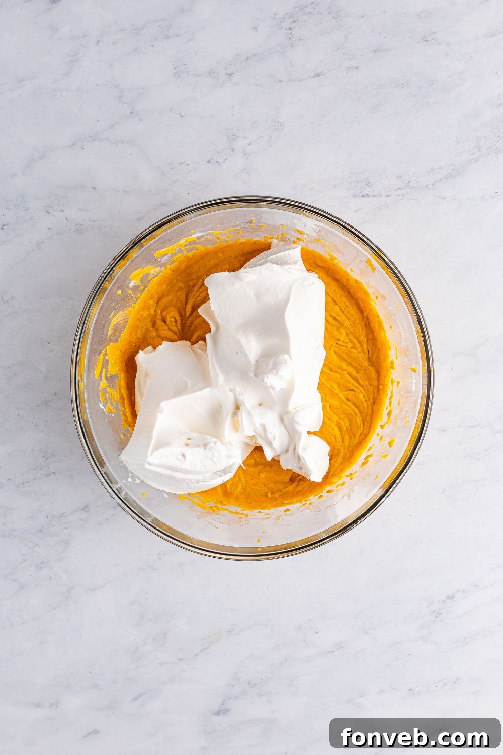 pumpkin cheesecake with whipped cream on top