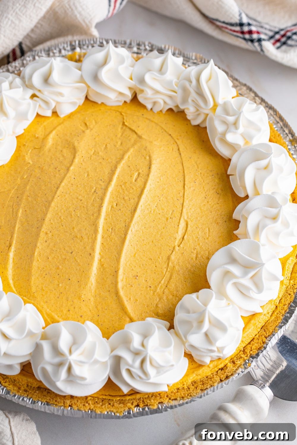 overhead view of pumpkin cheesecake in a pan on table