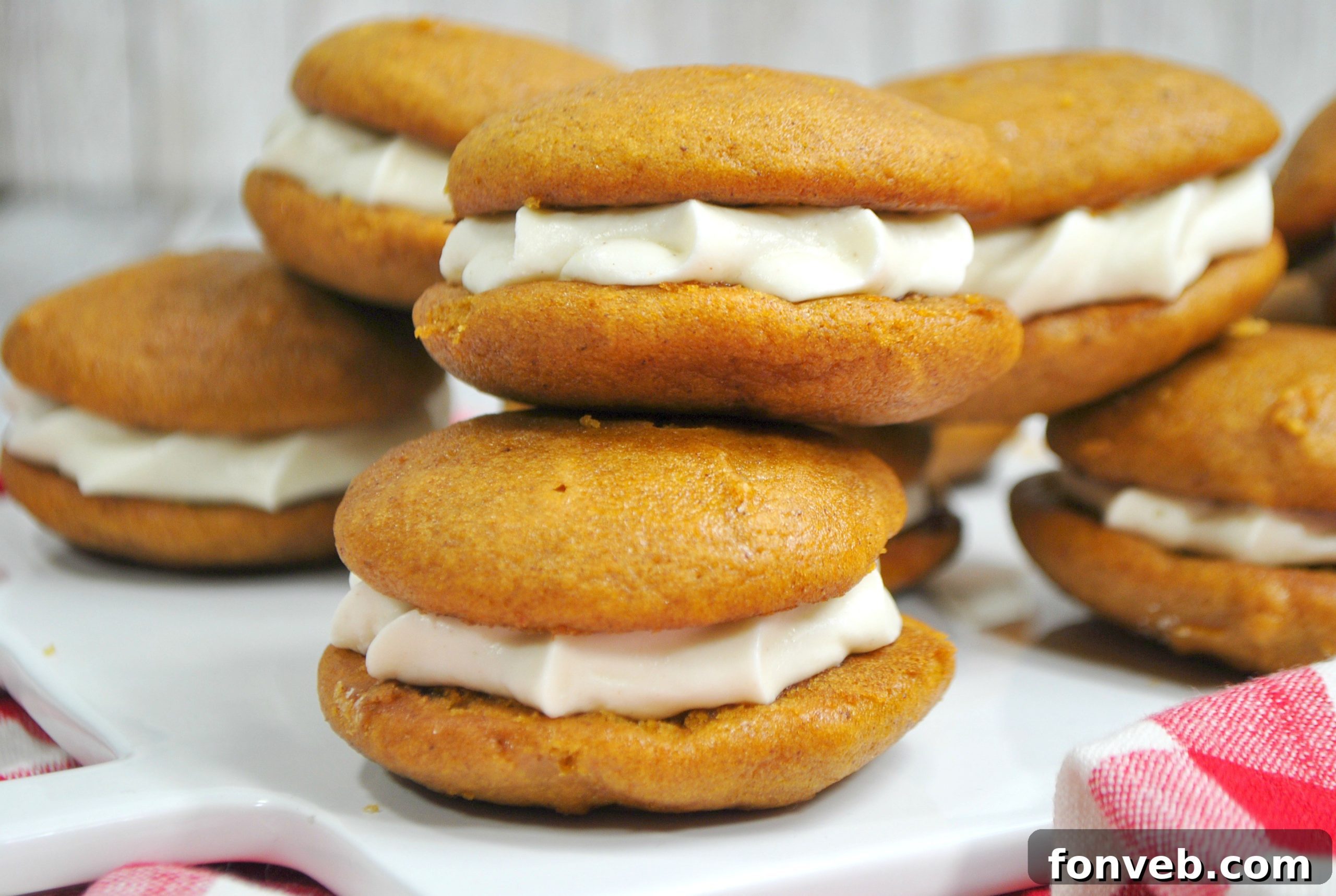 Close-up of a filled pumpkin whoopie pie, showing the moist cake and creamy filling