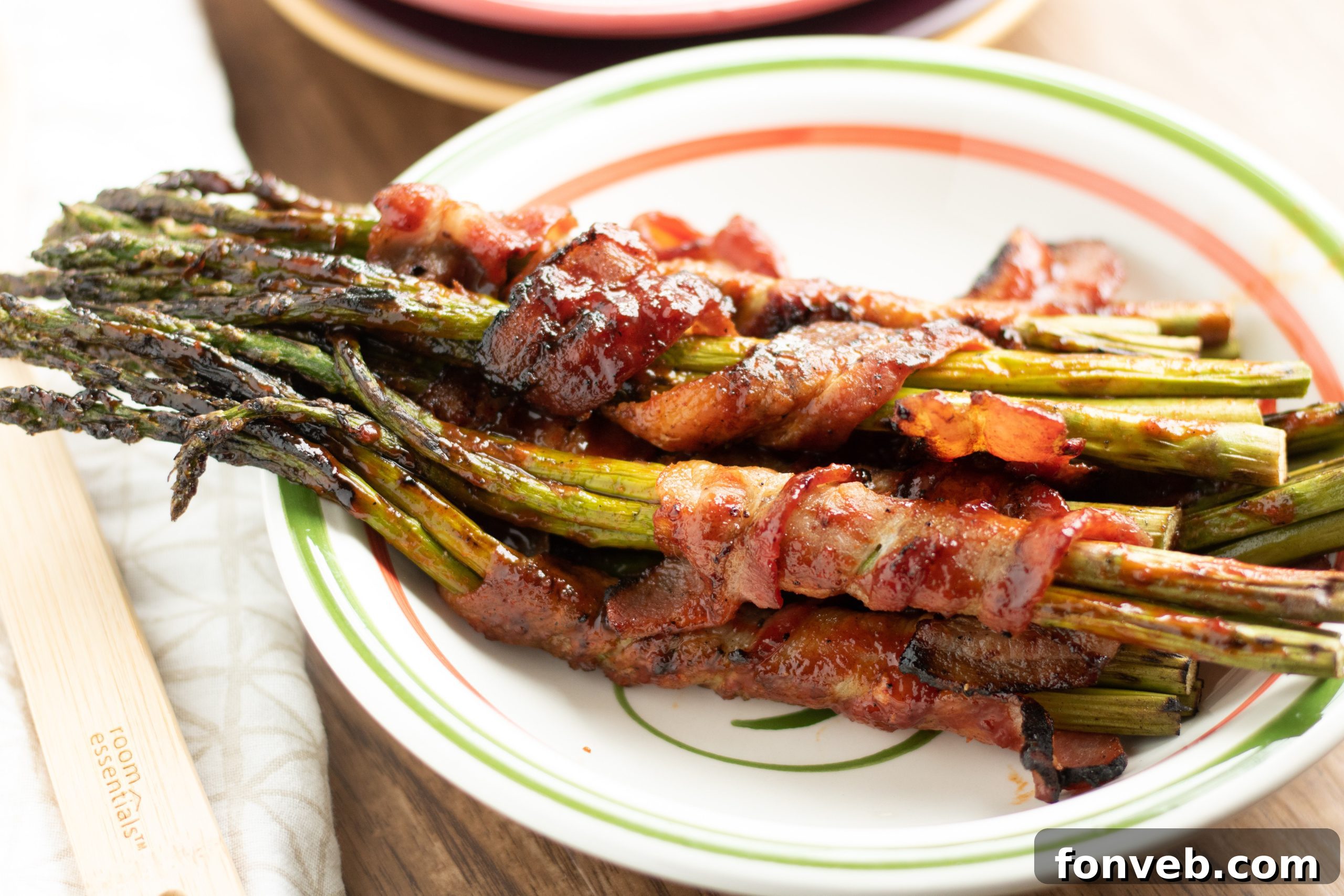 Hands demonstrating the 'bend and snap' method for trimming asparagus