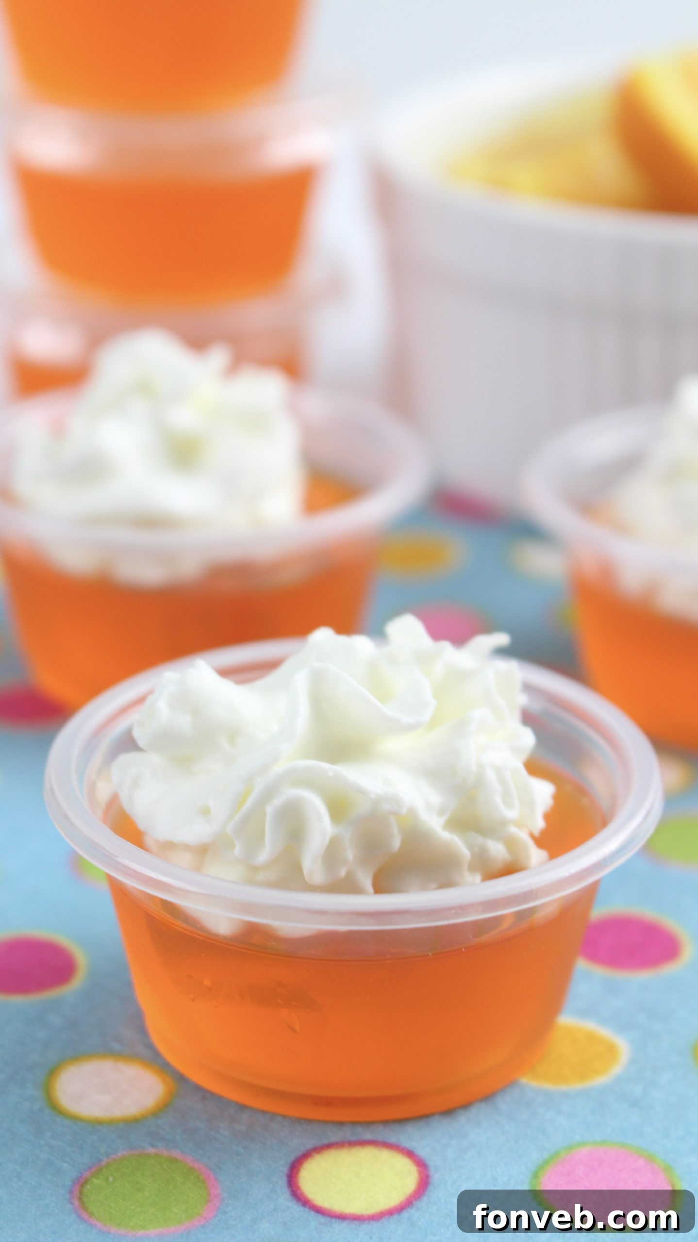 Delicious Orange Creamsicle Jello Shots lined up on a tray, ready for a party.