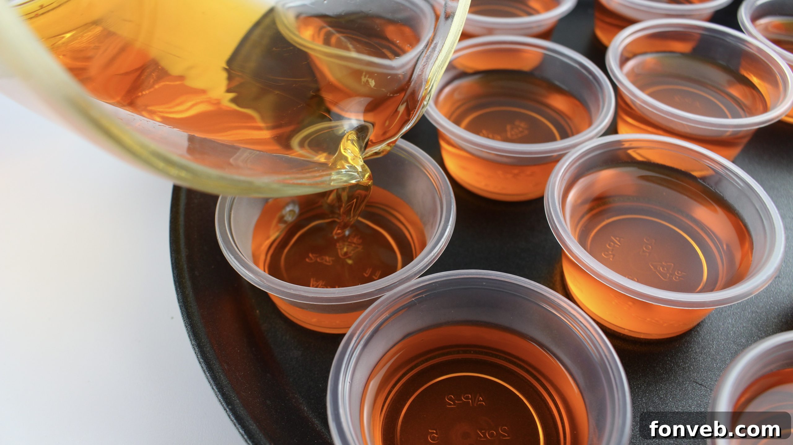 Close-up of Orange Creamsicle Jello Shots, showing their smooth, gelatinous texture and vibrant color.