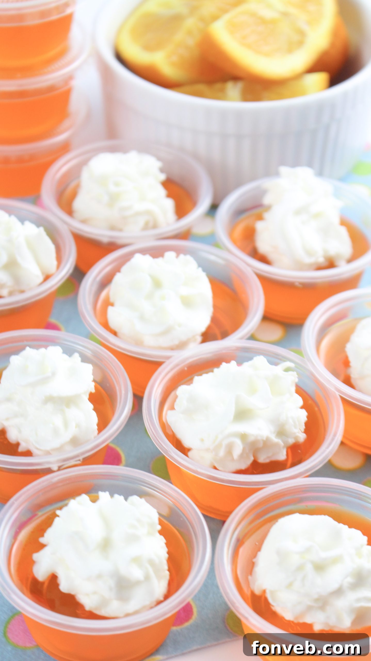 Another perspective of the Orange Creamsicle Jello Shots, highlighting their party-ready presentation.