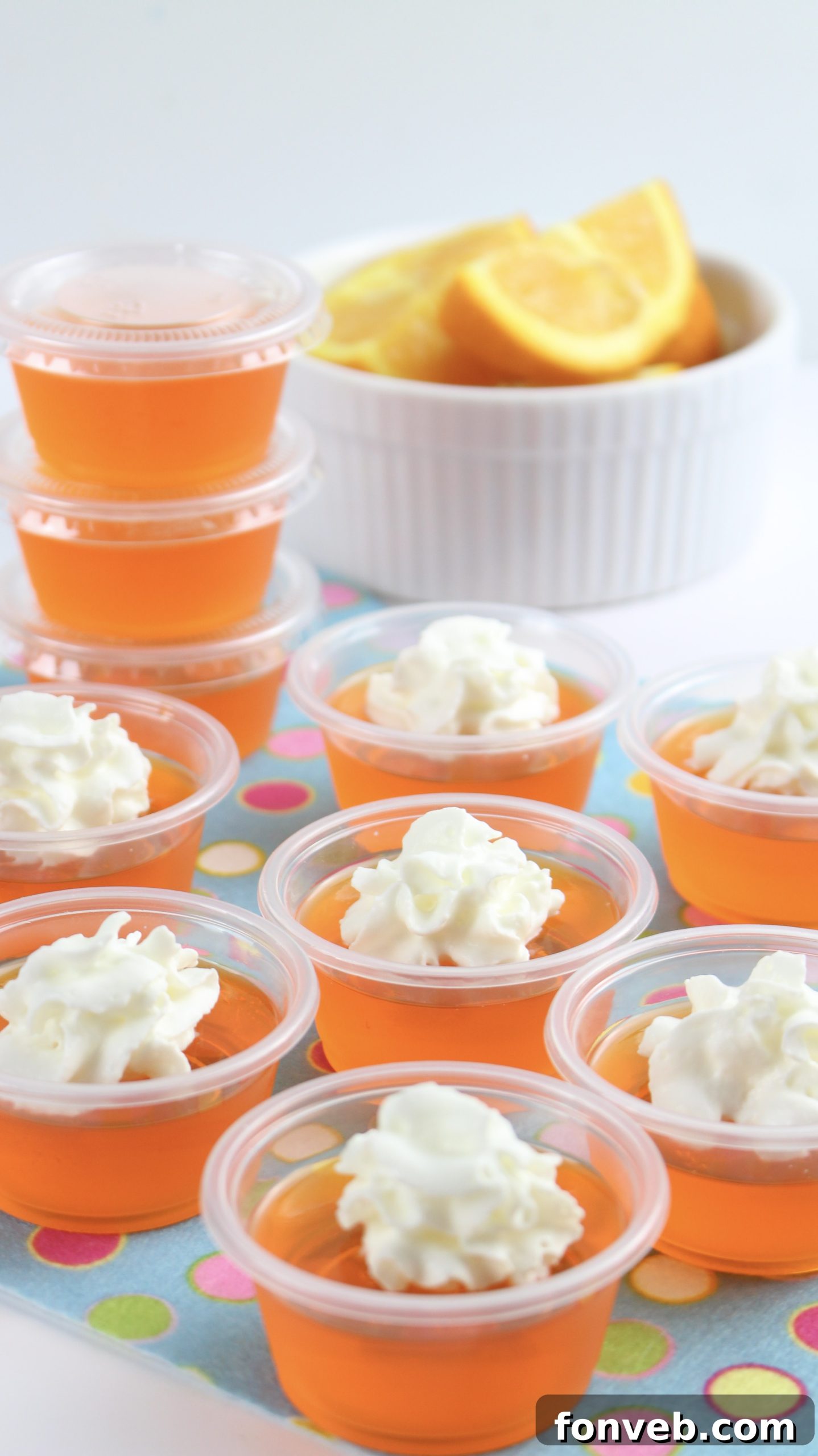 Final presentation of Orange Creamsicle Jello Shots, highlighting their vibrant color and creamy topping.