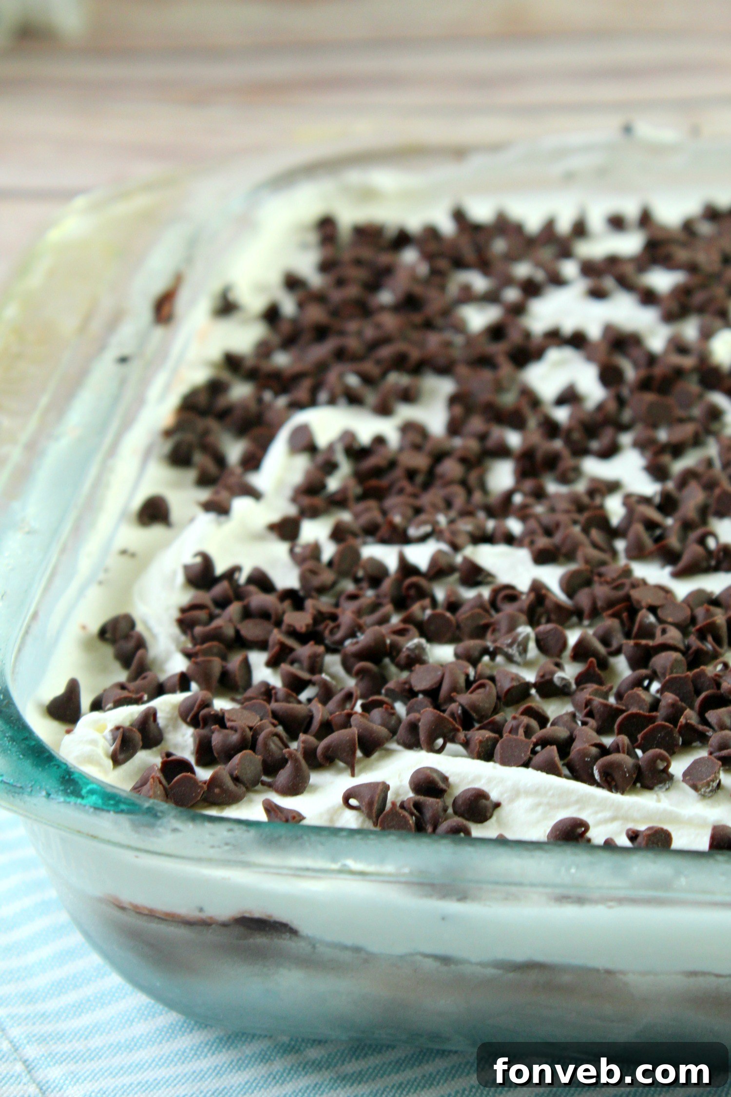 A close-up of the smooth, creamy layers of the No-Bake Chocolate Lasagna, showcasing the transition between the chocolate pudding and the whipped topping.