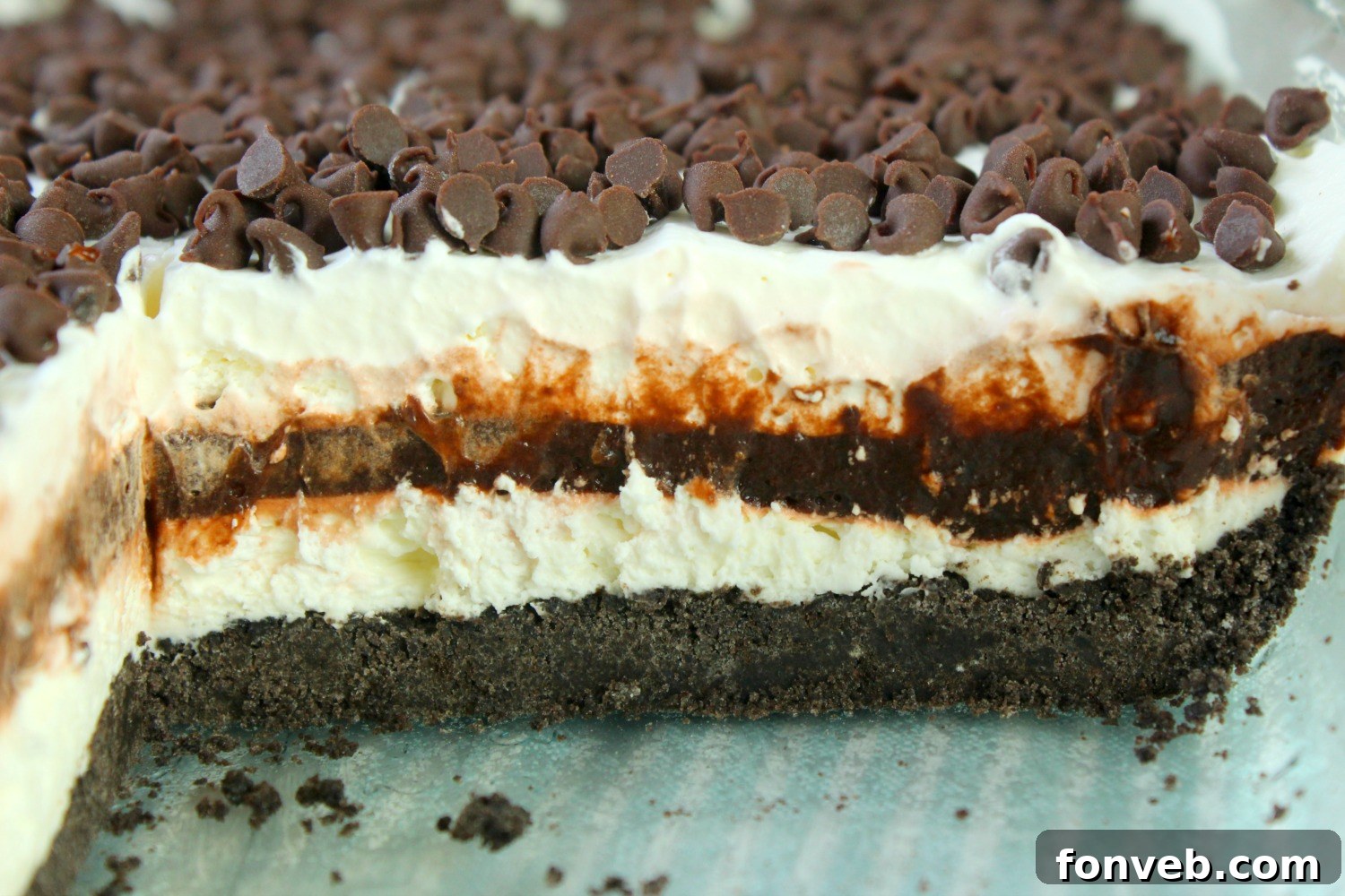 An overhead shot of a slice of No-Bake Chocolate Lasagna on a white plate, revealing all its luscious layers.
